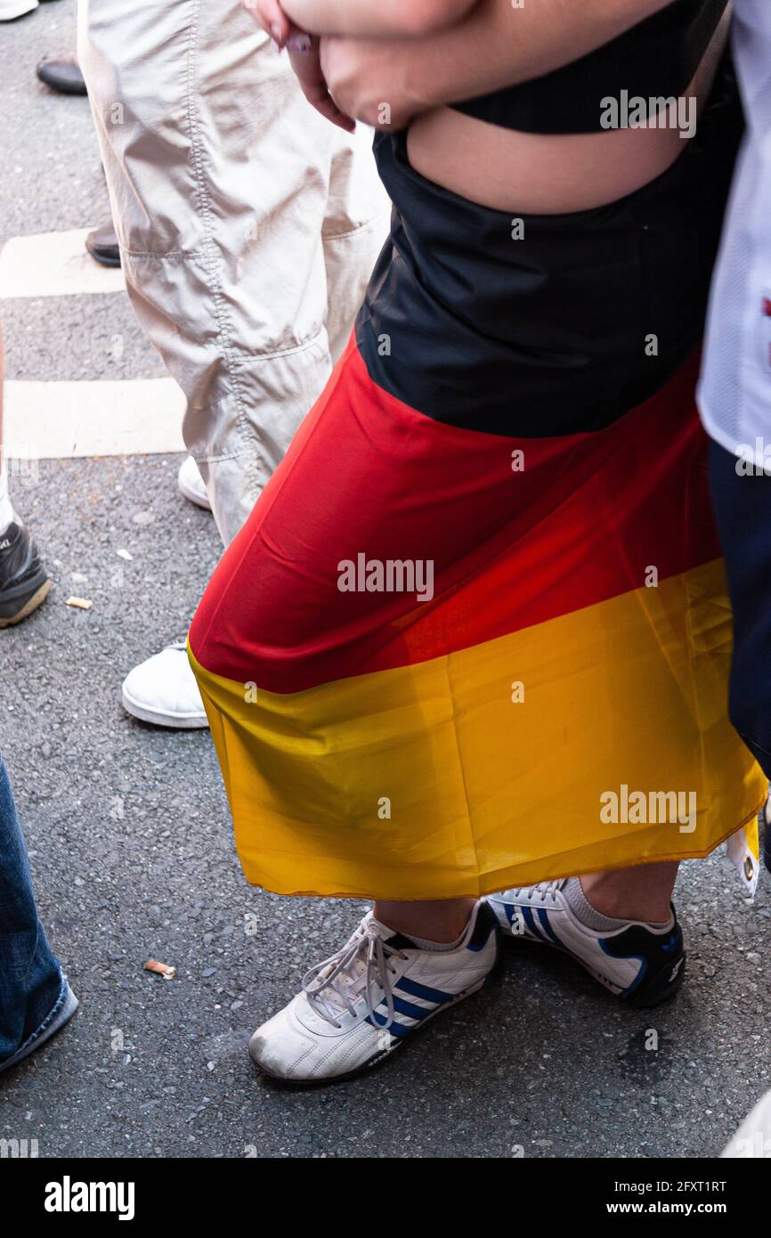 The German flag was tied around a woman's waist Stock Photo