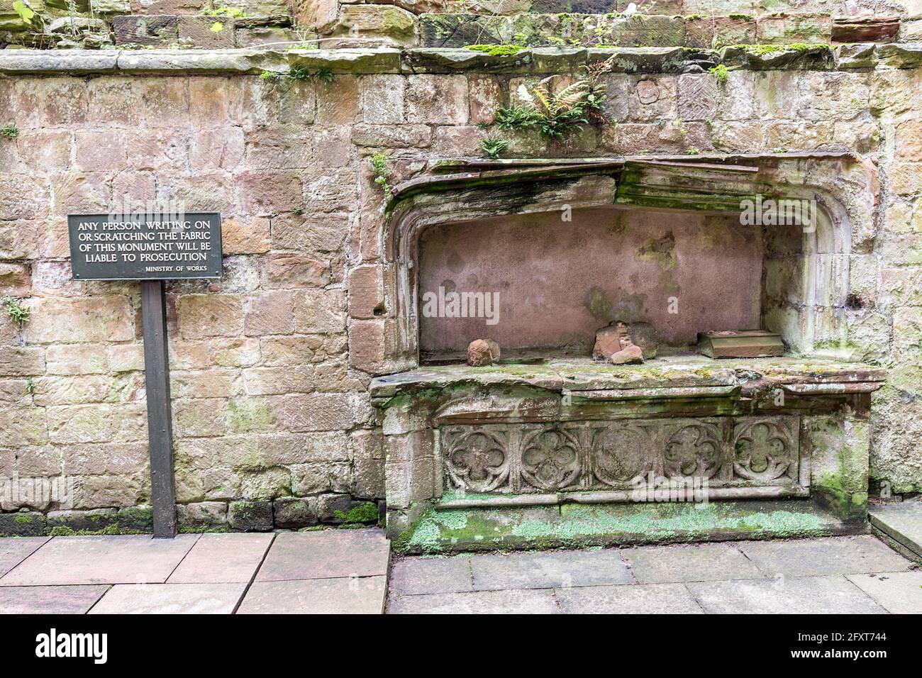 Warning sign about writing on walls of scheduled monument, Lanercost Priory, Cumbria, England, UK Stock Photo