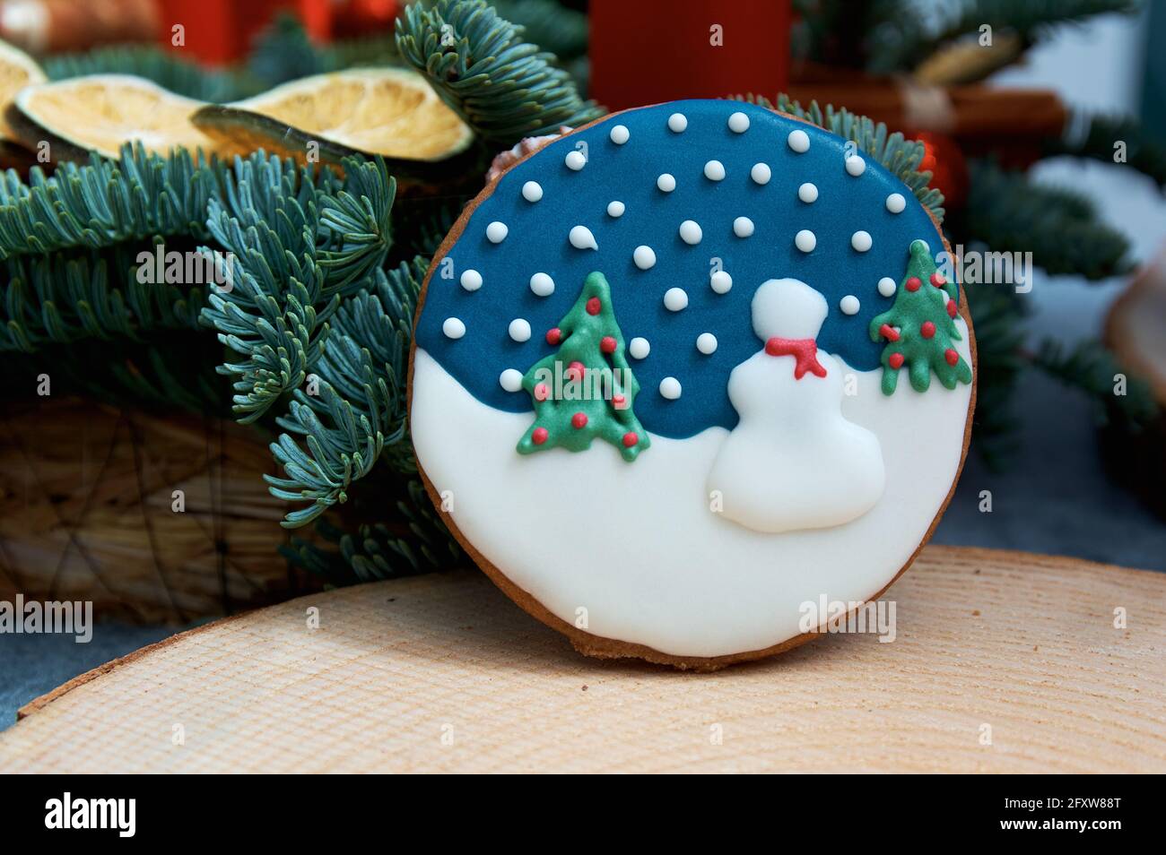 Christmas gingerbread with winter pattern. Christmas tree in the background. Stock Photo