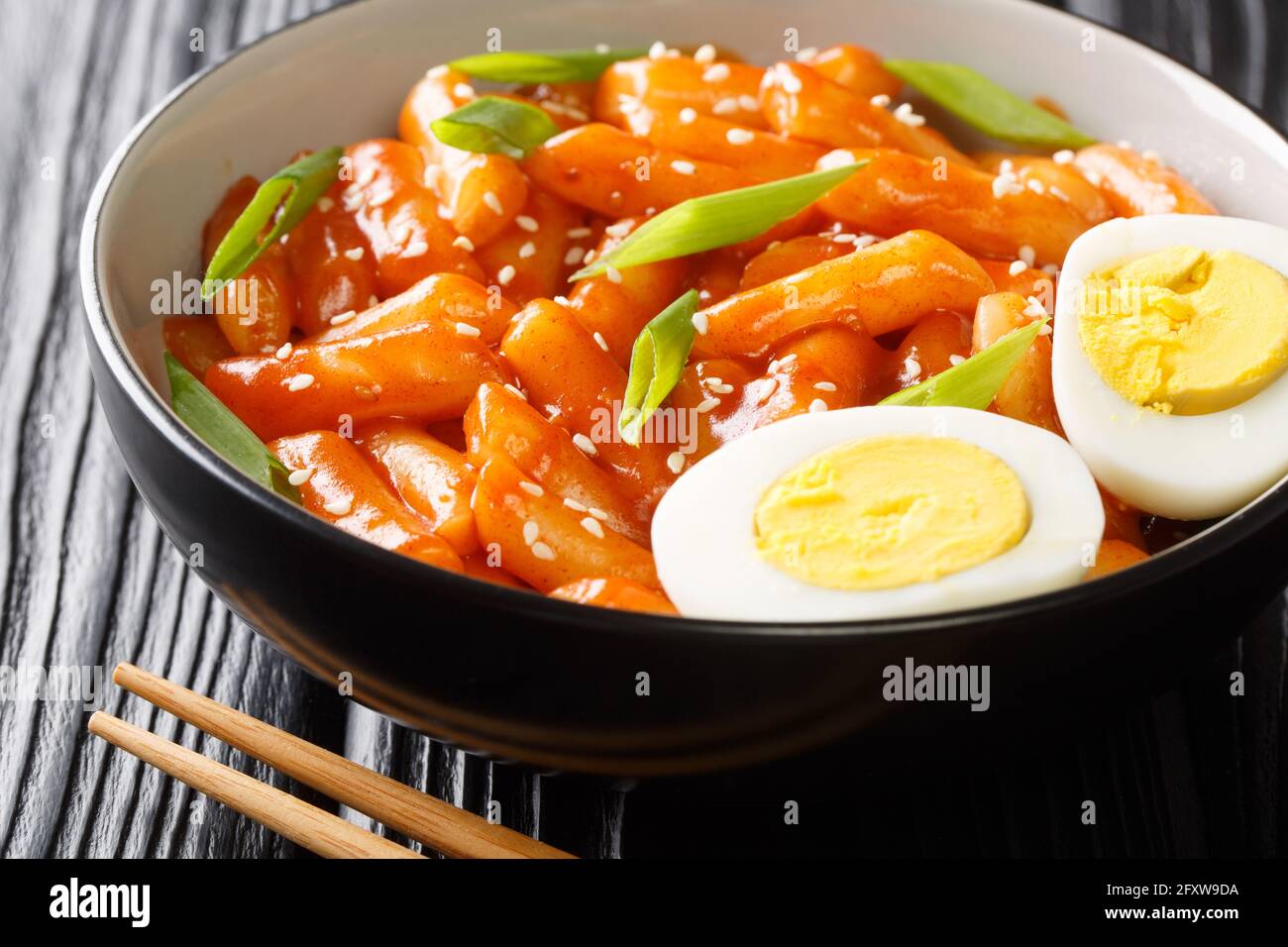 Hot and spicy rice cake Tteokbokki recipe close-up in a bowl on the table. horizontal Stock Photo
