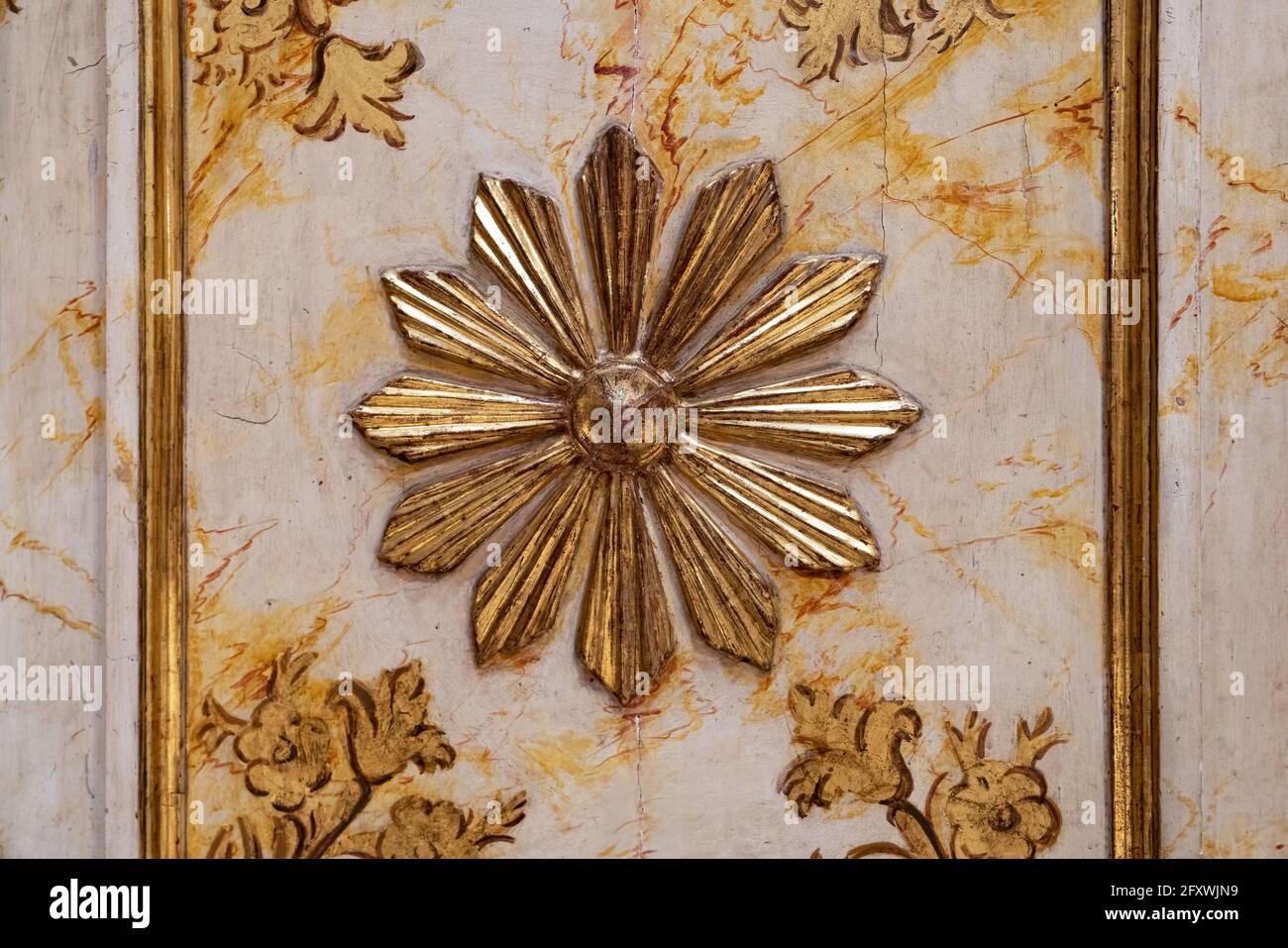 Daisy flower carved in gold color over wood Stock Photo