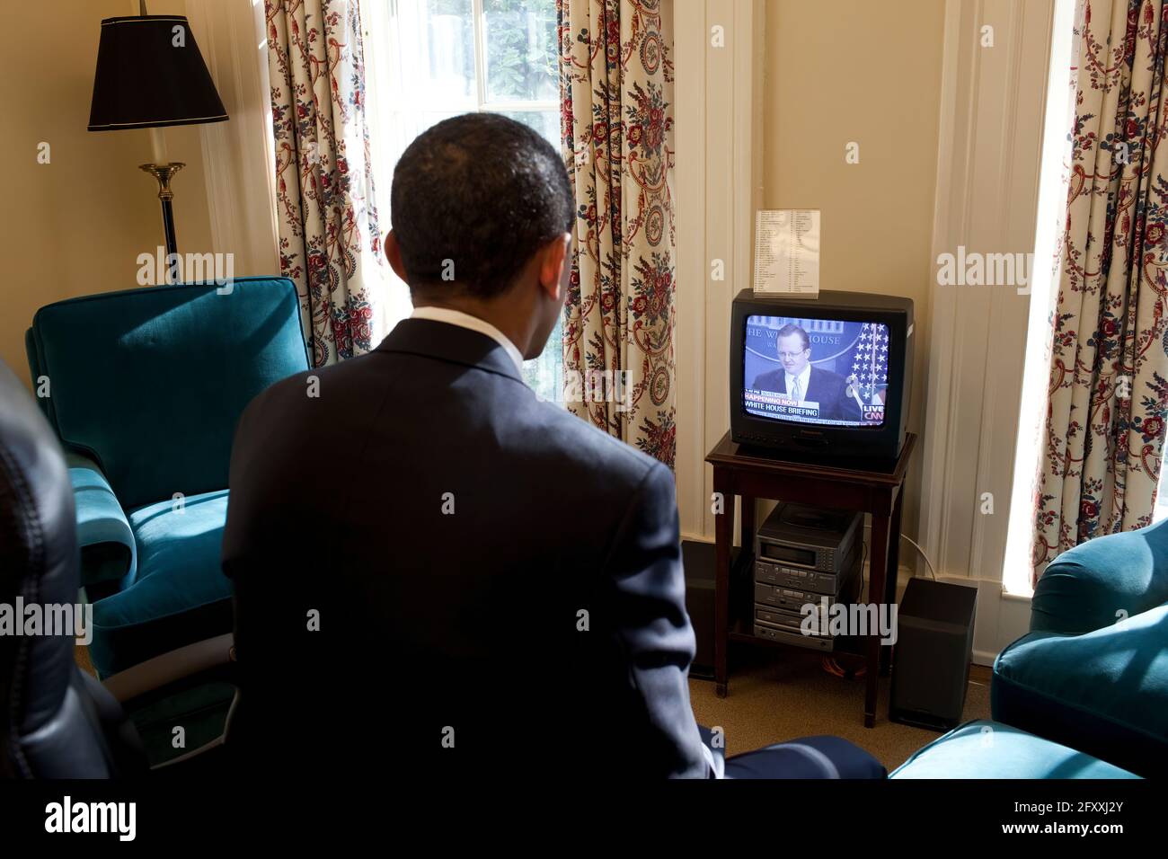 President Obama watches Press Secretary Robert Gibbs' first Press Briefing on television, in his private study off the Oval Office 1/22/09. White House Official Photo by Joyce N. Boghosian Stock Photo