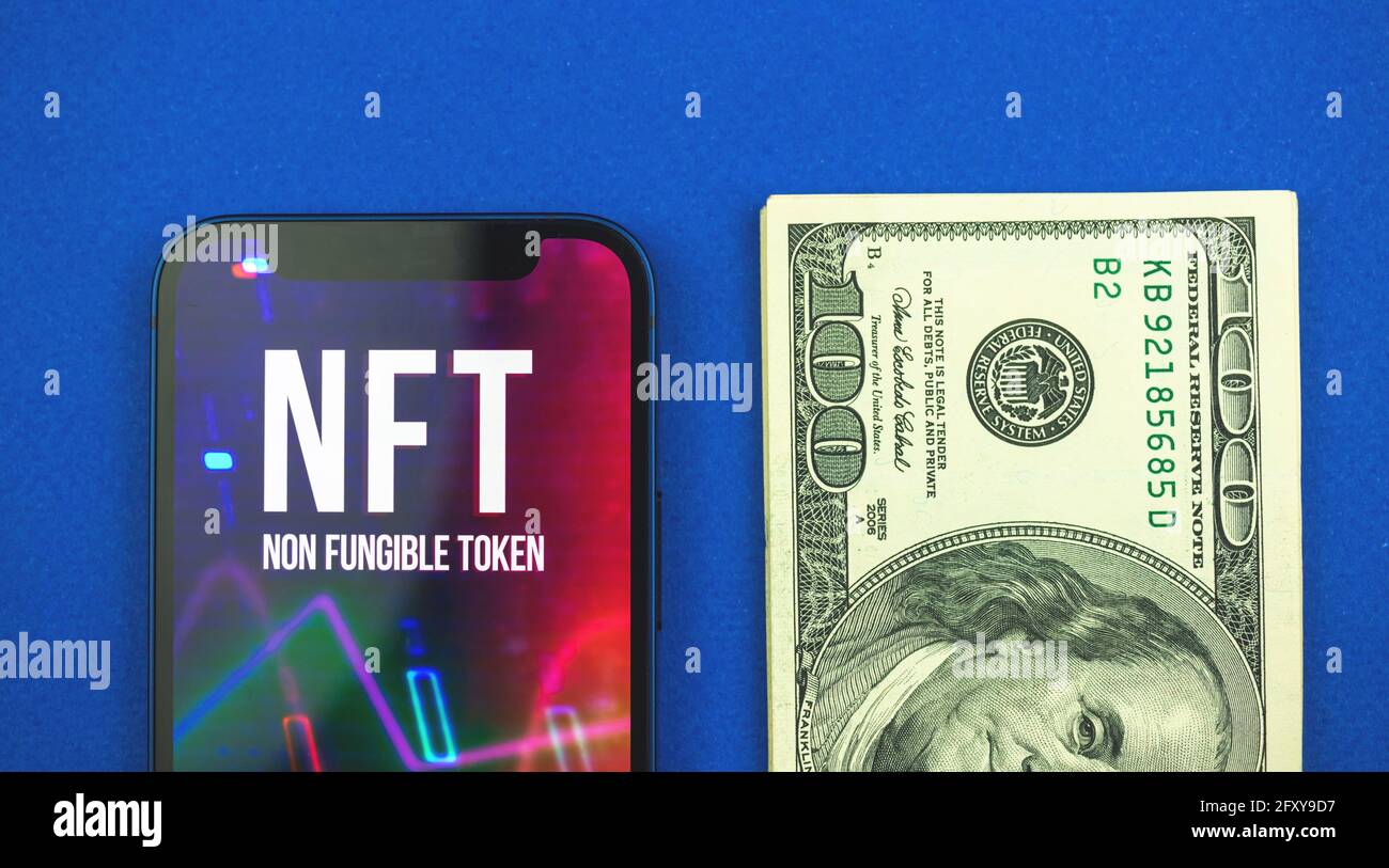 NFT token and dollar bills, money against future of new virtual and future crypto  currency and crypto art, top view and blue background Stock Photo - Alamy