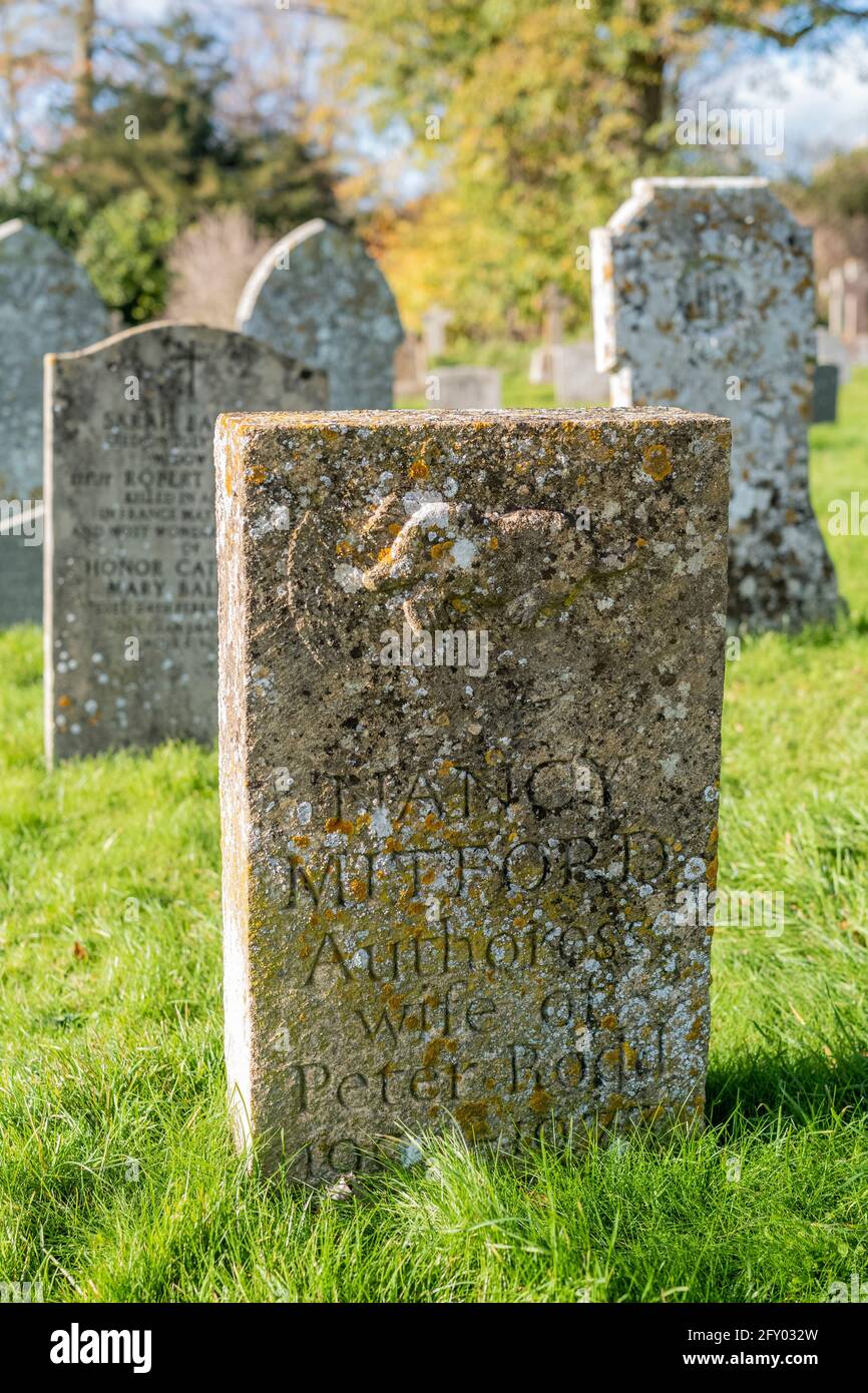 Headstones of the graves of the famous Mitford family - Nancy Mitford, author - in the churchyard of St Mary's Church in Swinbrook in The Cotswolds Stock Photo