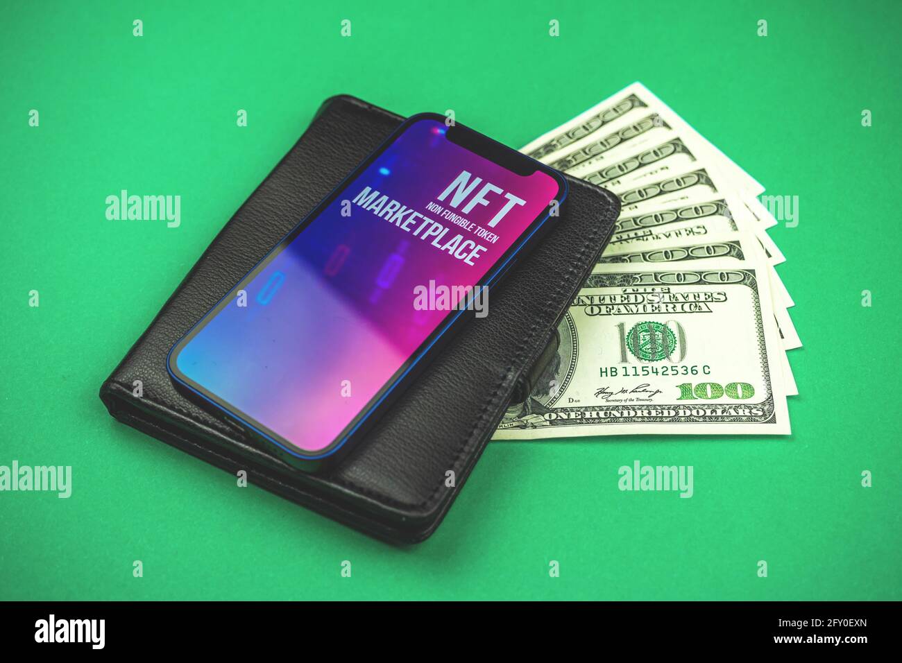Concept of commercial benefit with NFT cryptoart marketplace, new future  vision of art, black leather wallet with dollars and modern mobile phone  Stock Photo - Alamy