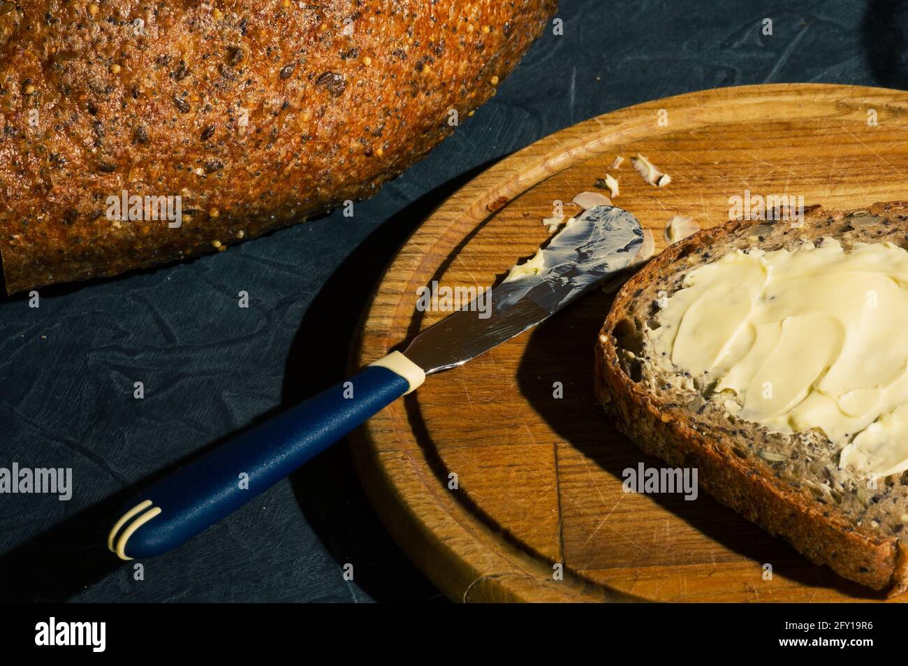 Slice of rustic natural yeastfree bread with flax, poppy seeds, sesame