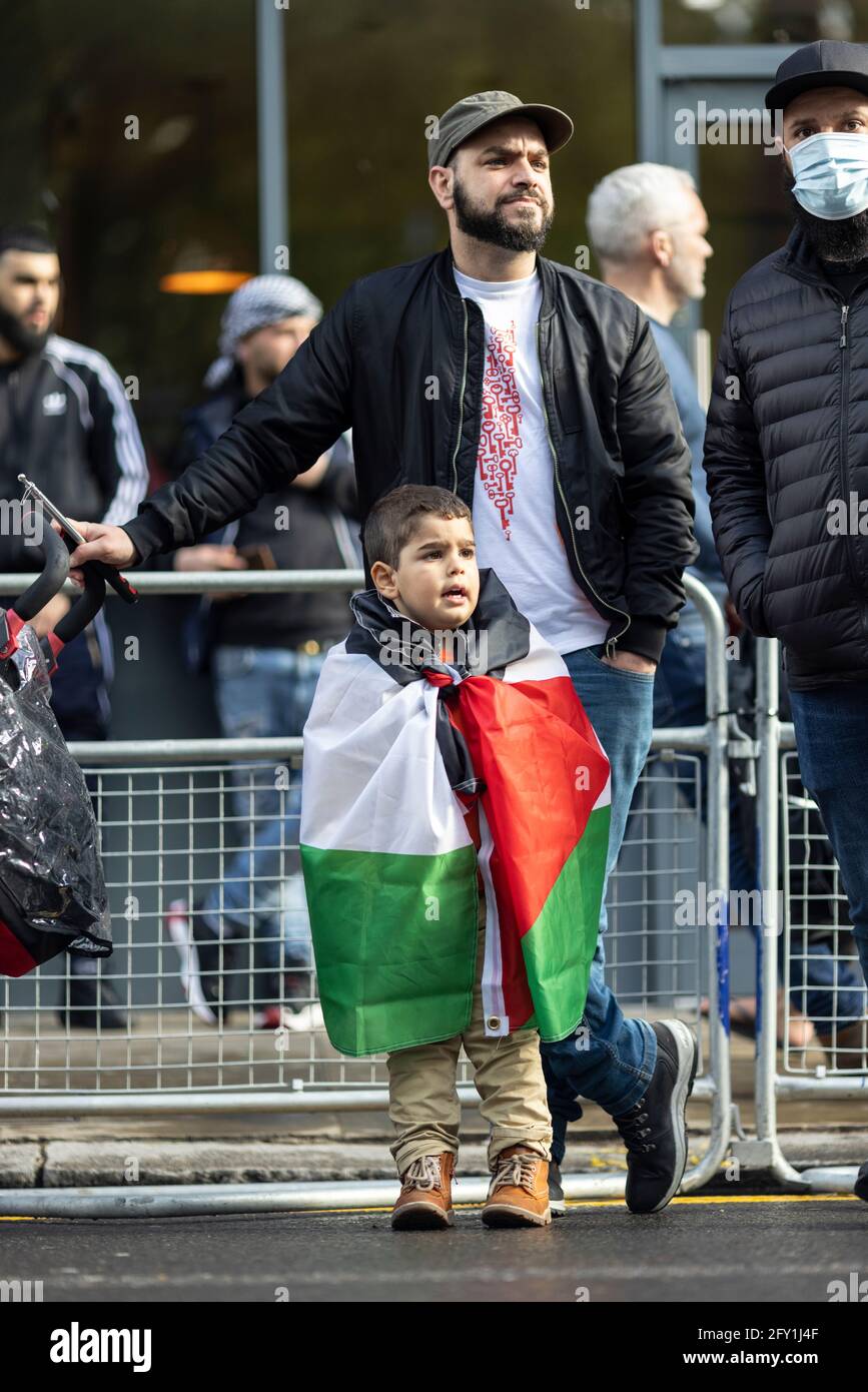 A young boy draped in a Palestinian flag, Free Palestine Protest, Embassy of Israel, London, 22 May 2021 Stock Photo