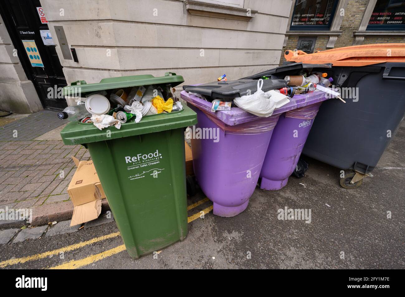Overflowing rubbish bins in the street Stock Photo Alamy