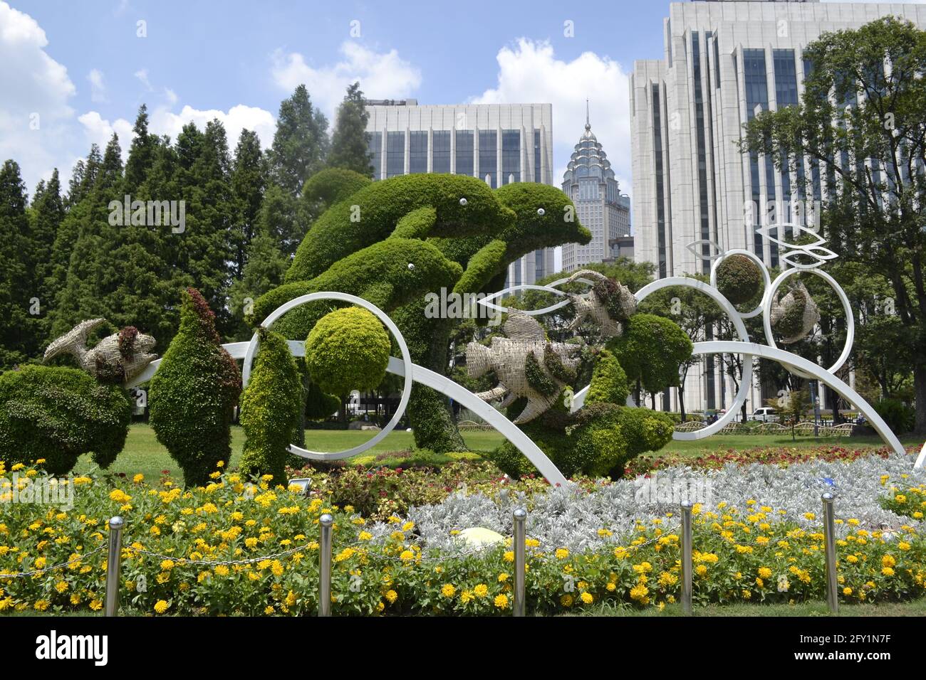 Dolphin shaped hedges along with small well trimmed shrubs in a beautiful and peaceful park in the city of Tianjin, China Stock Photo