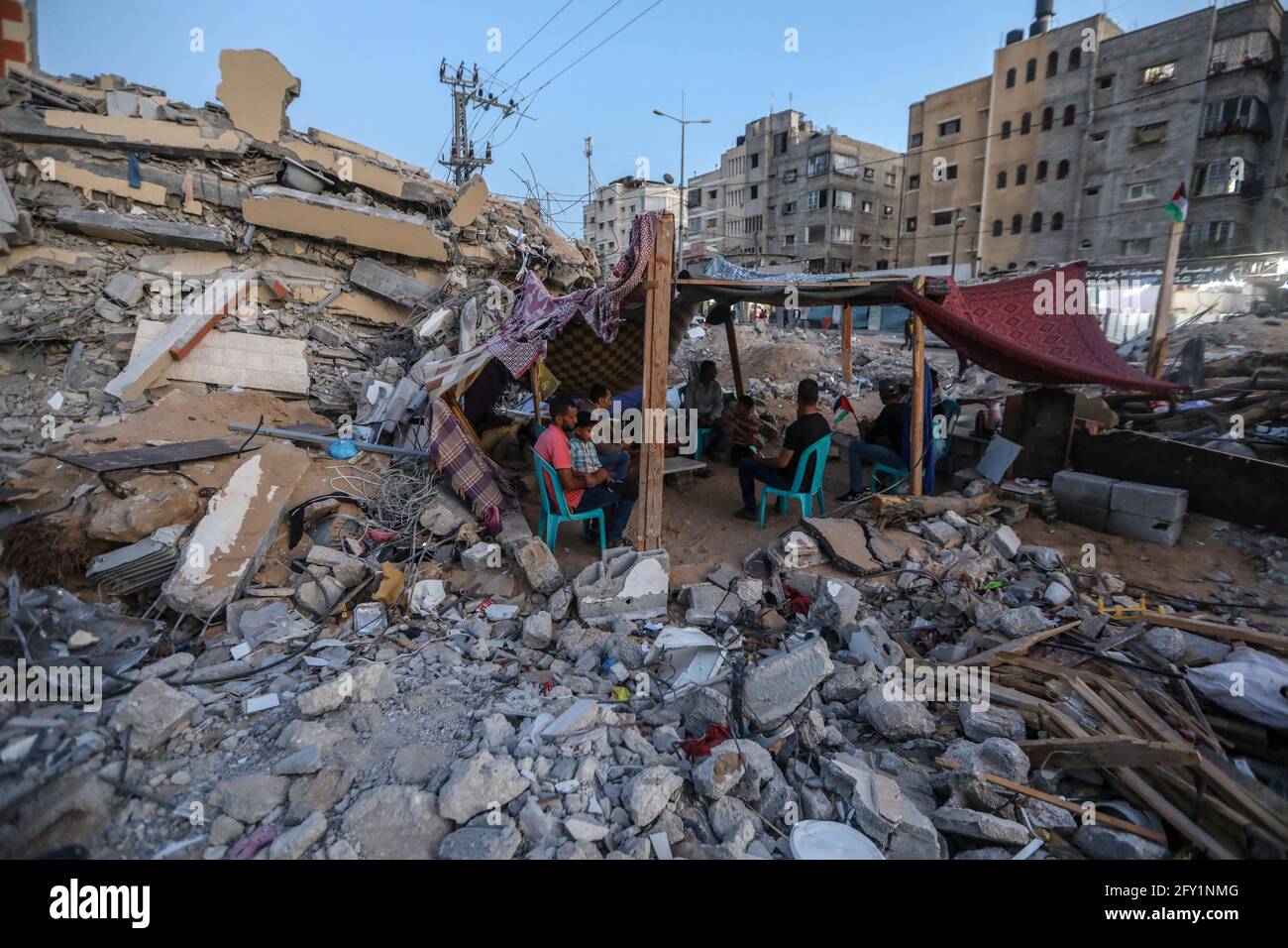 A Palestinian family lives in a tent on the rubble of their destroyed ...