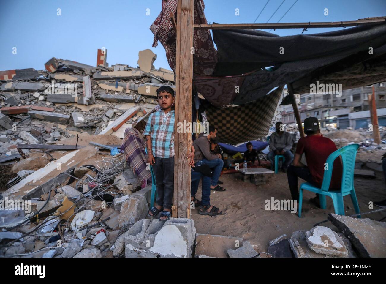 A Palestinian family lives in a tent on the rubble of their destroyed ...