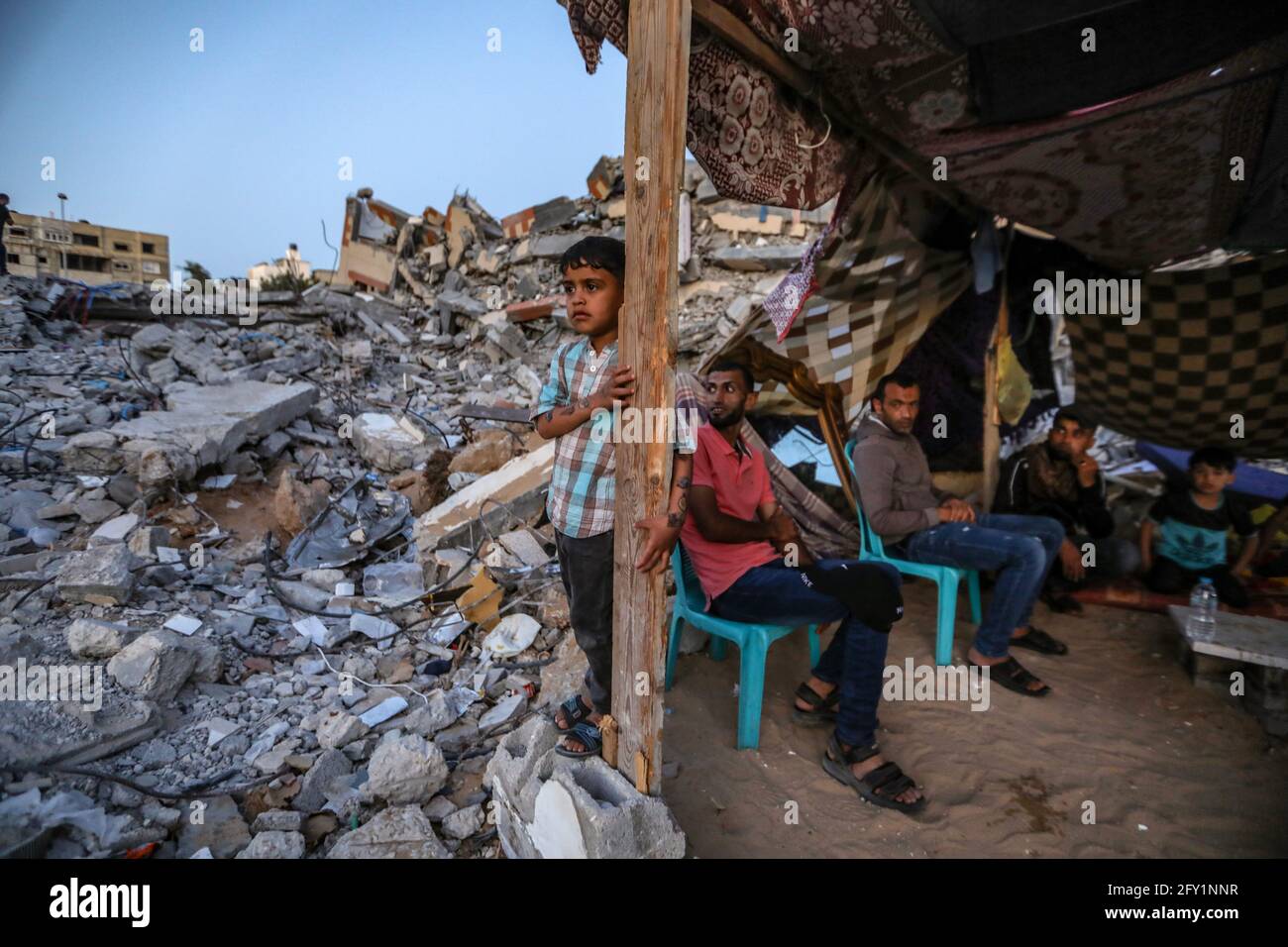A Palestinian family lives in a tent on the rubble of their destroyed ...