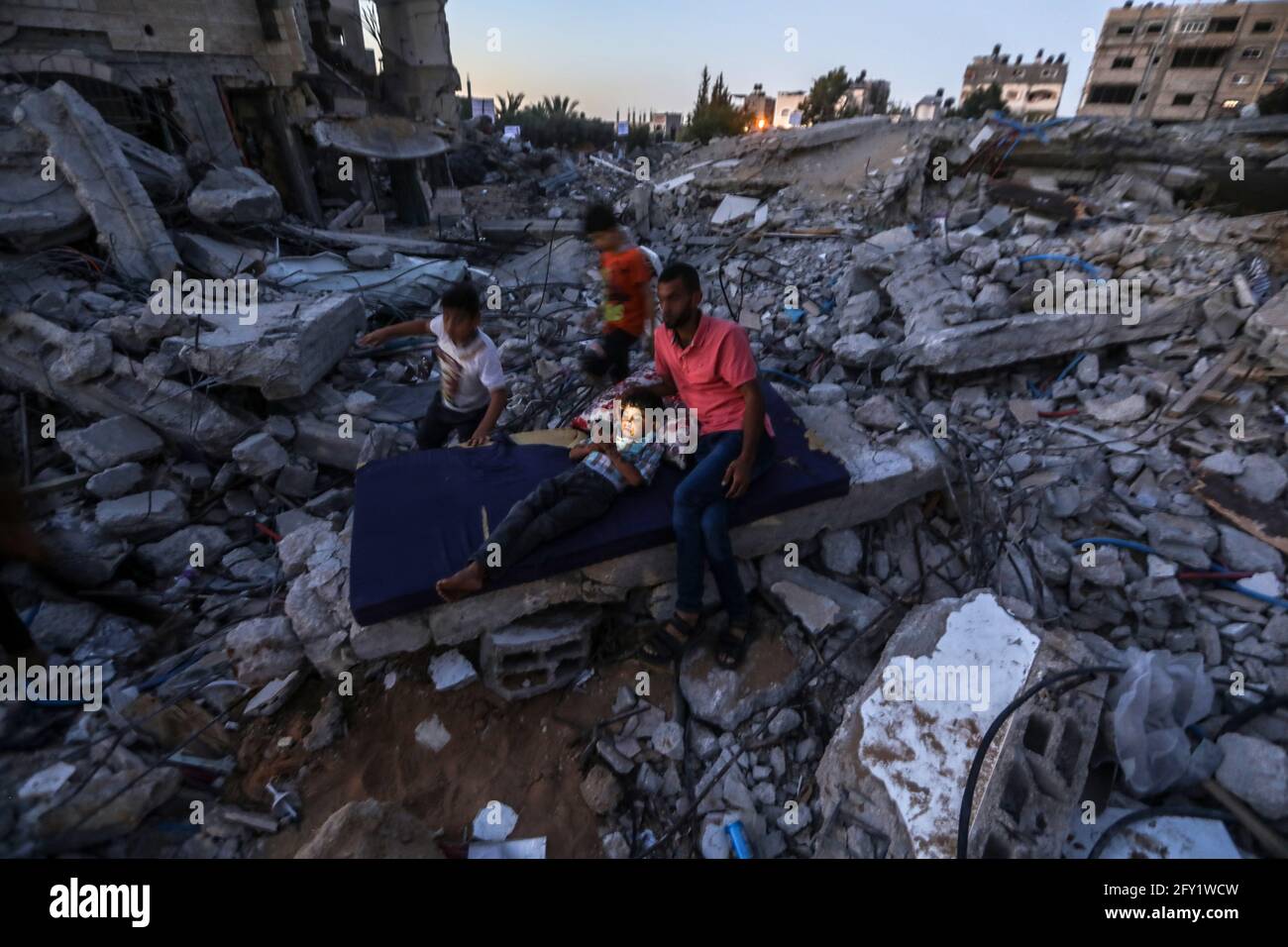 A Palestinian family lives in a tent on the rubble of their destroyed ...