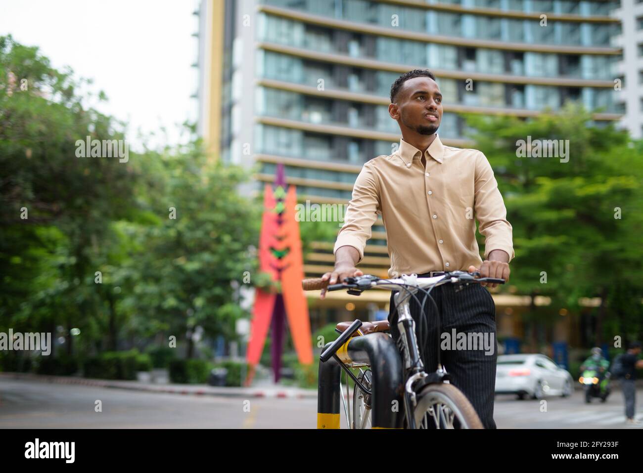Portrait of handsome black young African businessman outdoors in city Stock Photo