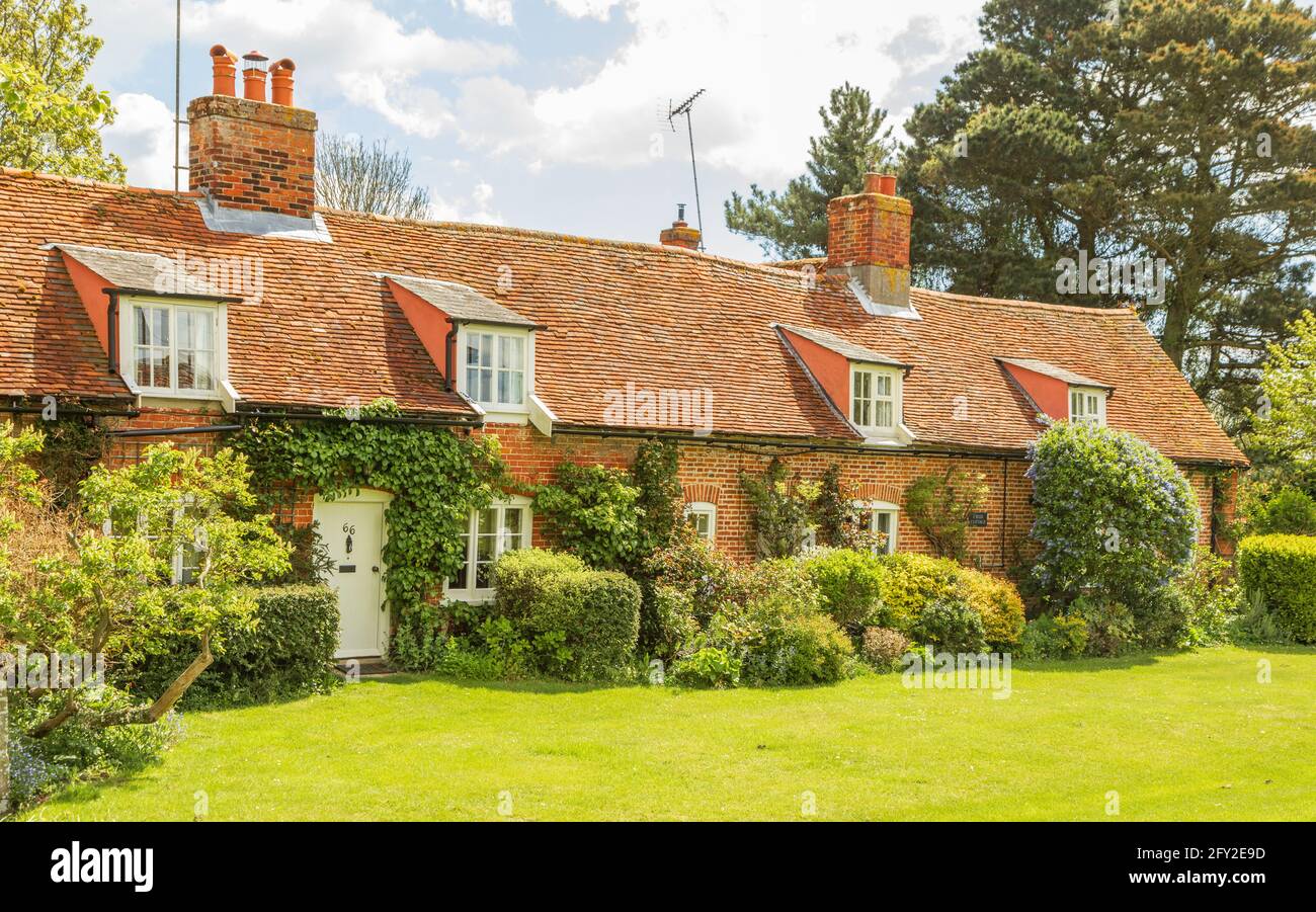 Row of attractive, old, traditional English village cottages on a sunny