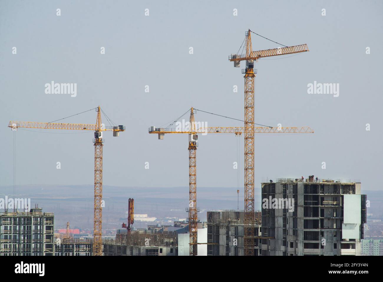 Construction yard of multistory living building with cranes Stock Photo