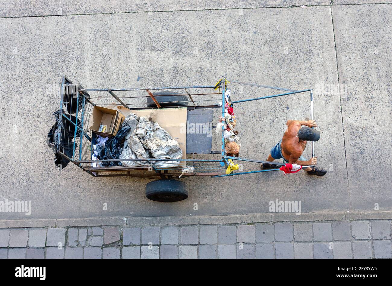 top view of a homeless man pulling a garbage cart on the streets in Brazil Stock Photo