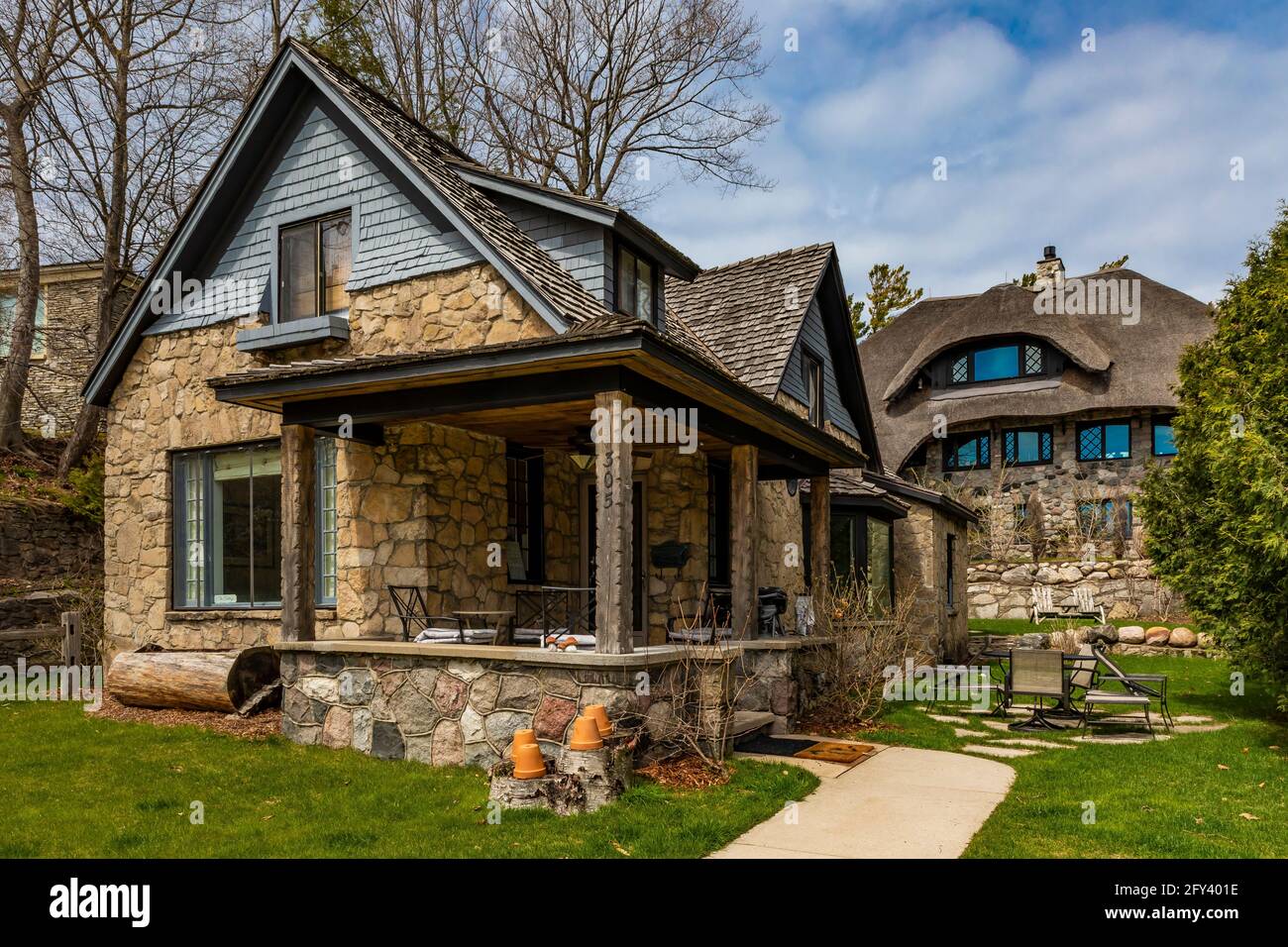 One of the Mushroom Houses, at 305 Clinton Street, with The Thatch House behind, both designed by architect Earl Young in the 20th Century, Charlevoix Stock Photo