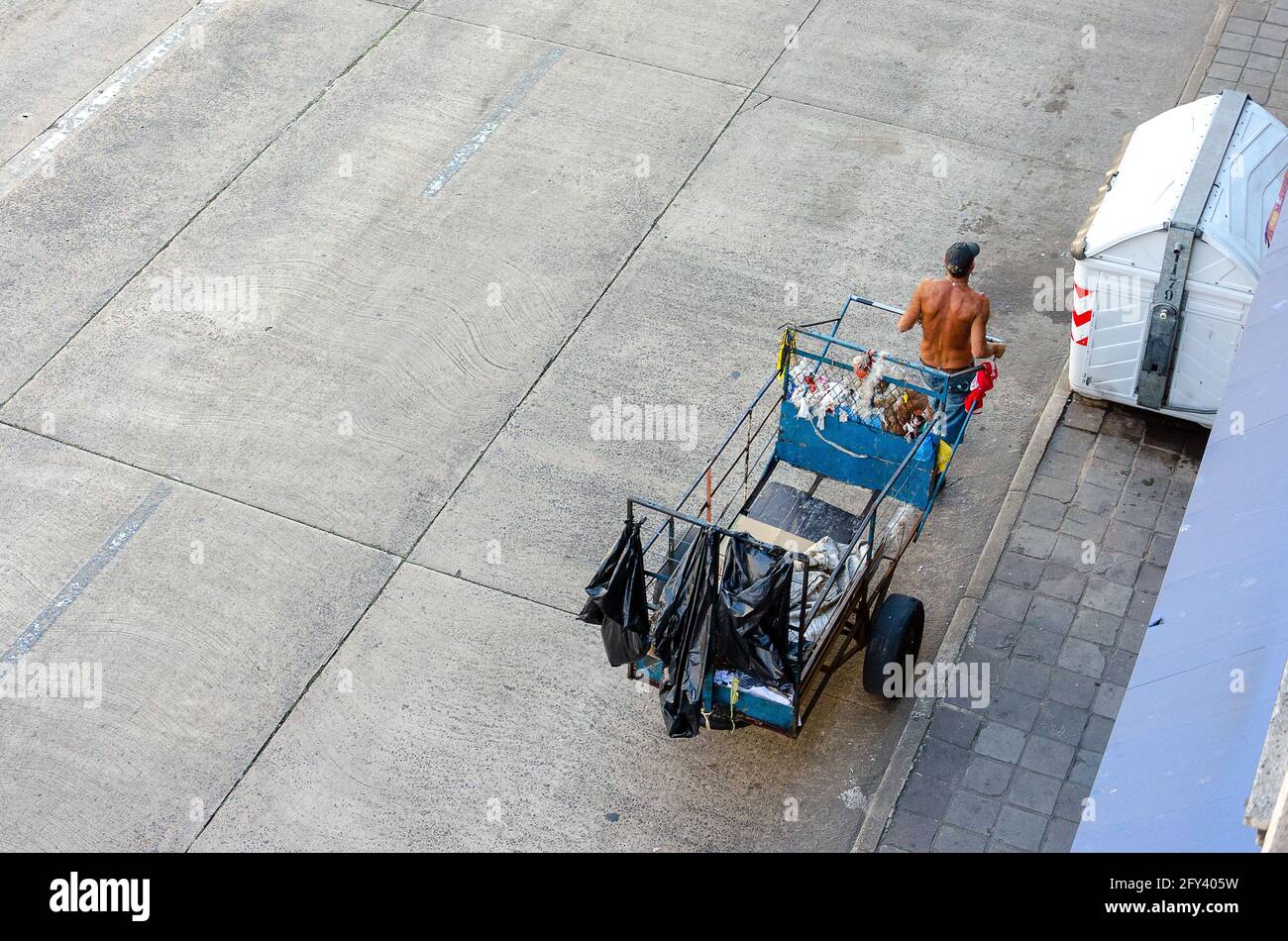 top view of a homeless man pulling a garbage cart on the streets in Brazil Stock Photo