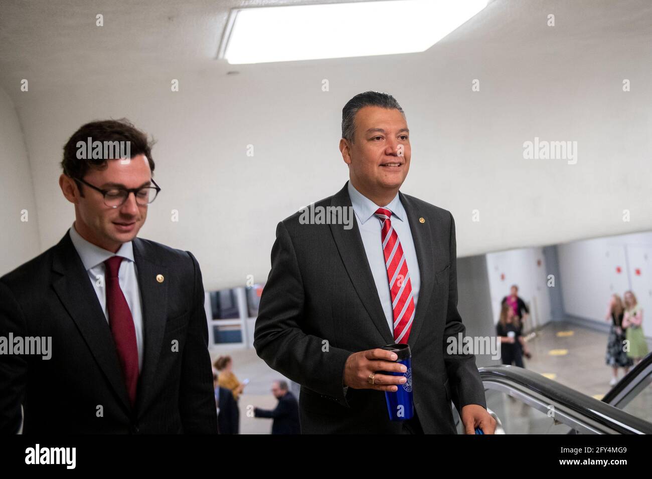 United States Senator Alex Padilla (Democrat of California), right, and United States Senator Jon Ossoff (Democrat of Georgia), left, walk through the Senate subway, during a vote at the US Capitol in Washington, DC, Thursday, May 27, 2021. Credit: Rod Lamkey/CNP /MediaPunch Stock Photo