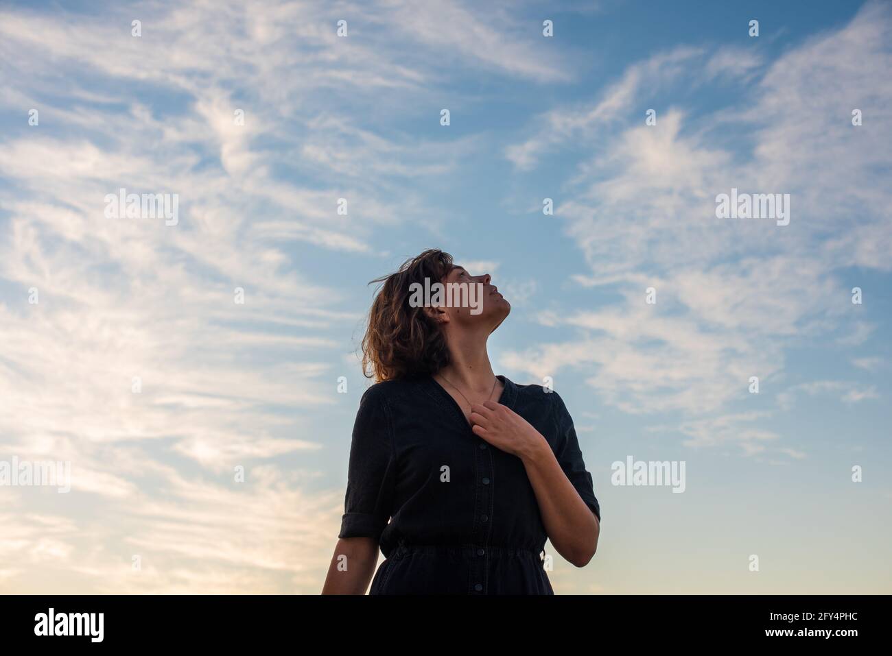 Woman looking up at sky hi-res stock photography and images - Alamy