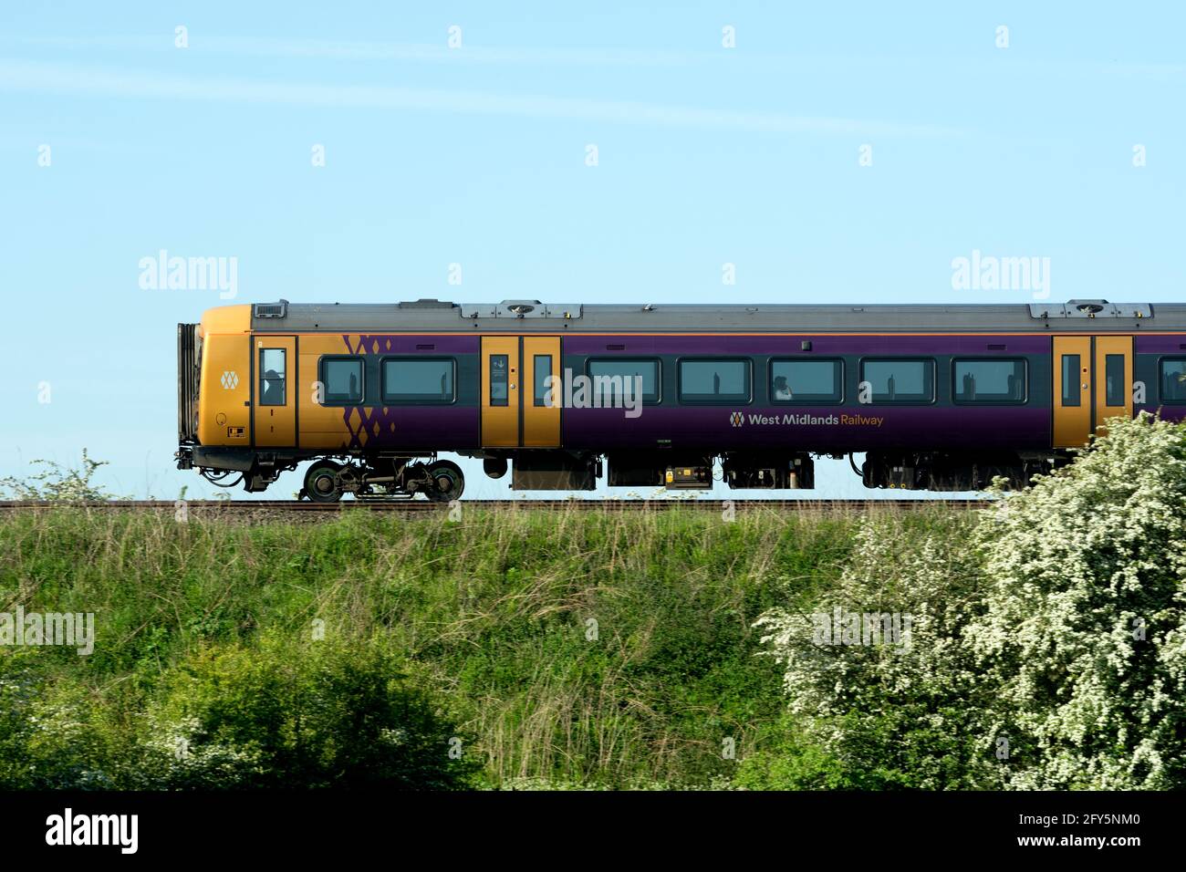 West Midlands Railway class 172 diesel train, side view in spring, Warwickshire, UK Stock Photo