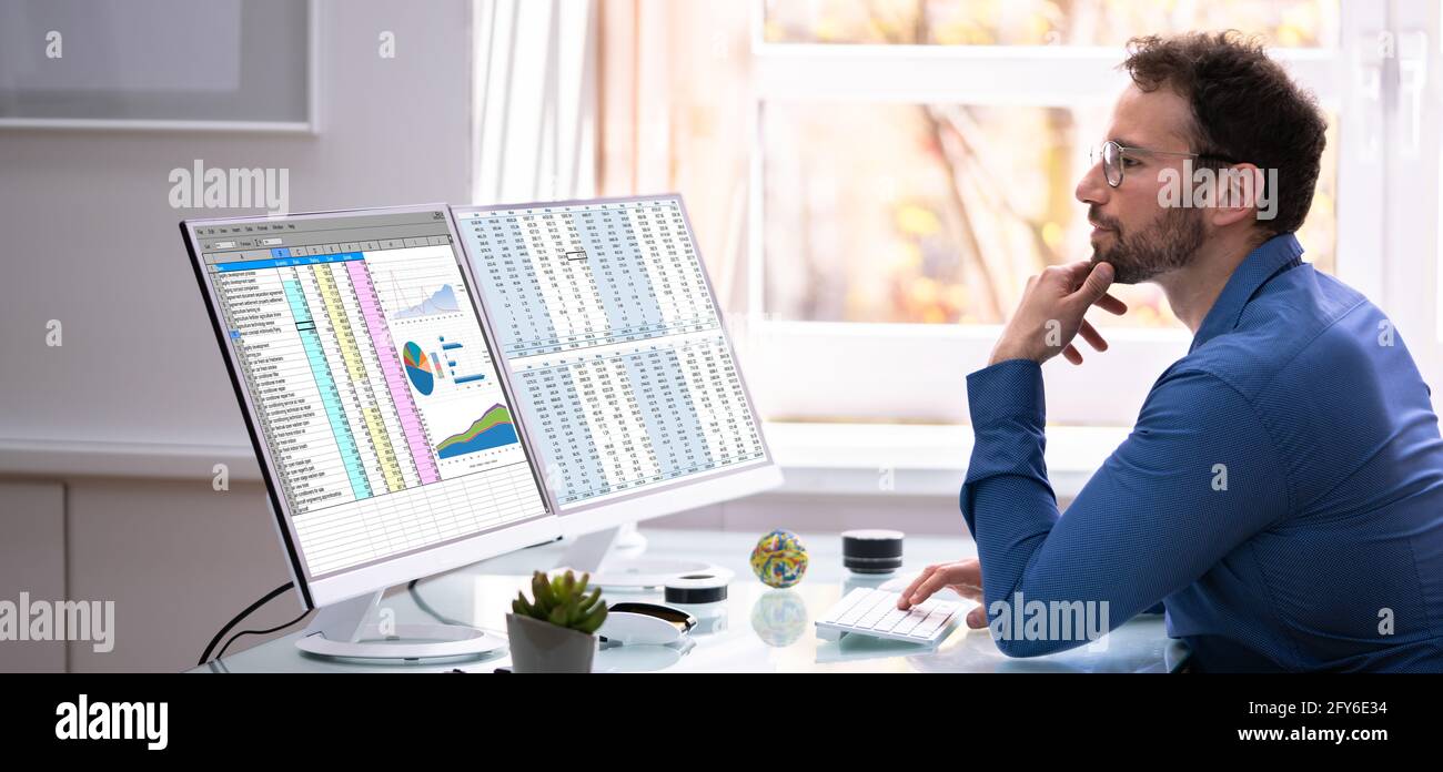 Analyst Employee Using Spreadsheet On Computer Screen Stock Photo