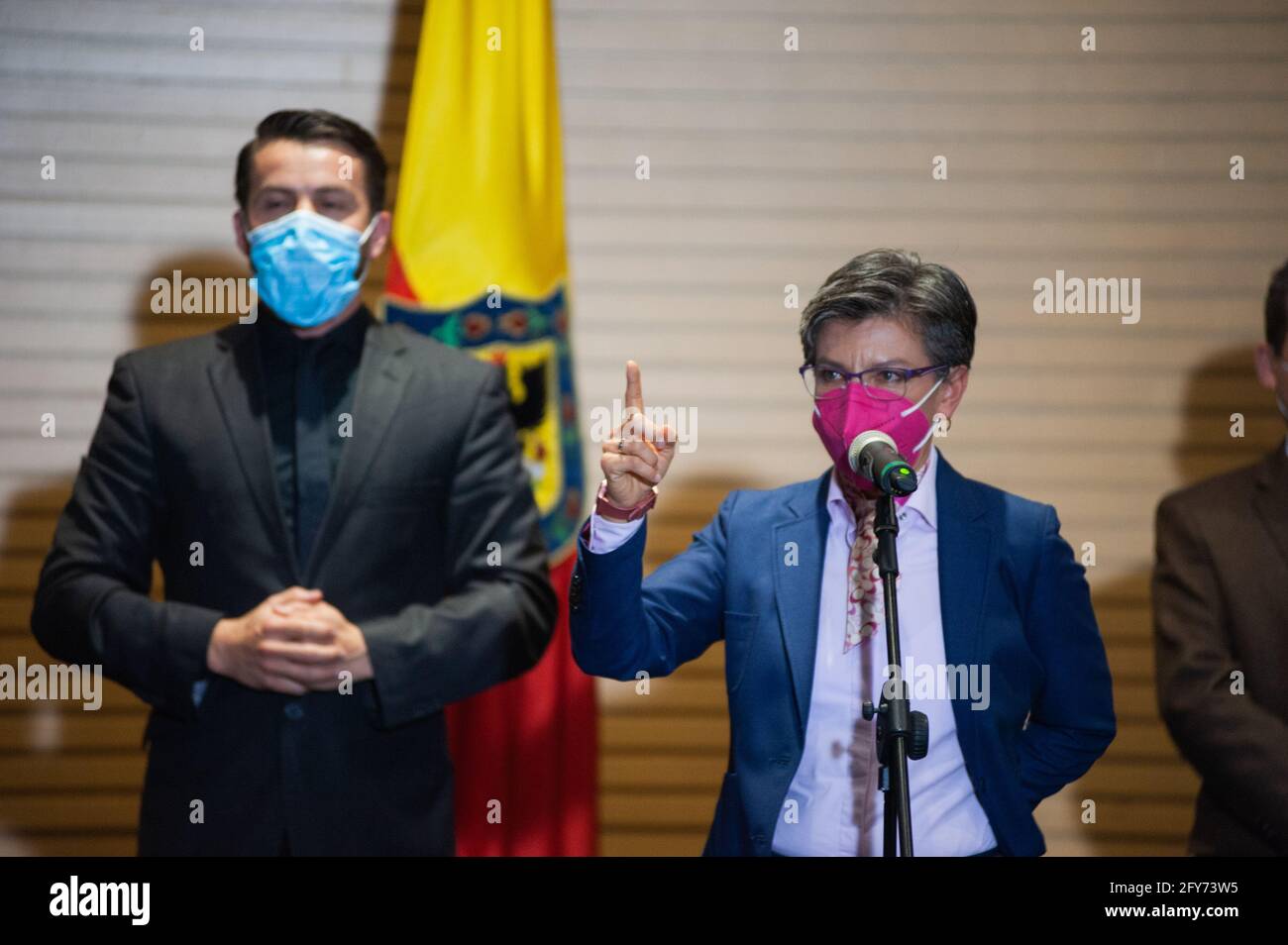 Mayor of Bogota, Claudia Lopez, Secretary of Health Alejandro Gomez and Nicolas Uribe, president of Bogota's Chamber of Comerce hold a live on television press conference announcing the COVID-19 measures that will be eased by june 8, 2021, in Bogota, Colombia on May 27, 2021. Stock Photo
