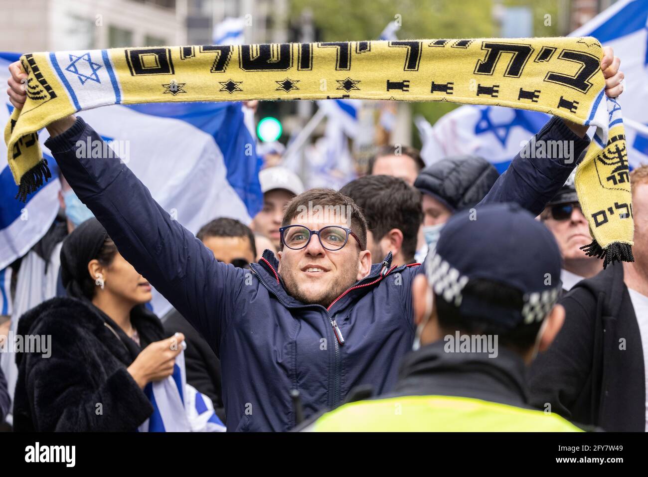 Portrait of protester holding up scarf, Zionist demonstration, Embassy of Israel, London, 23 May 2021 Stock Photo