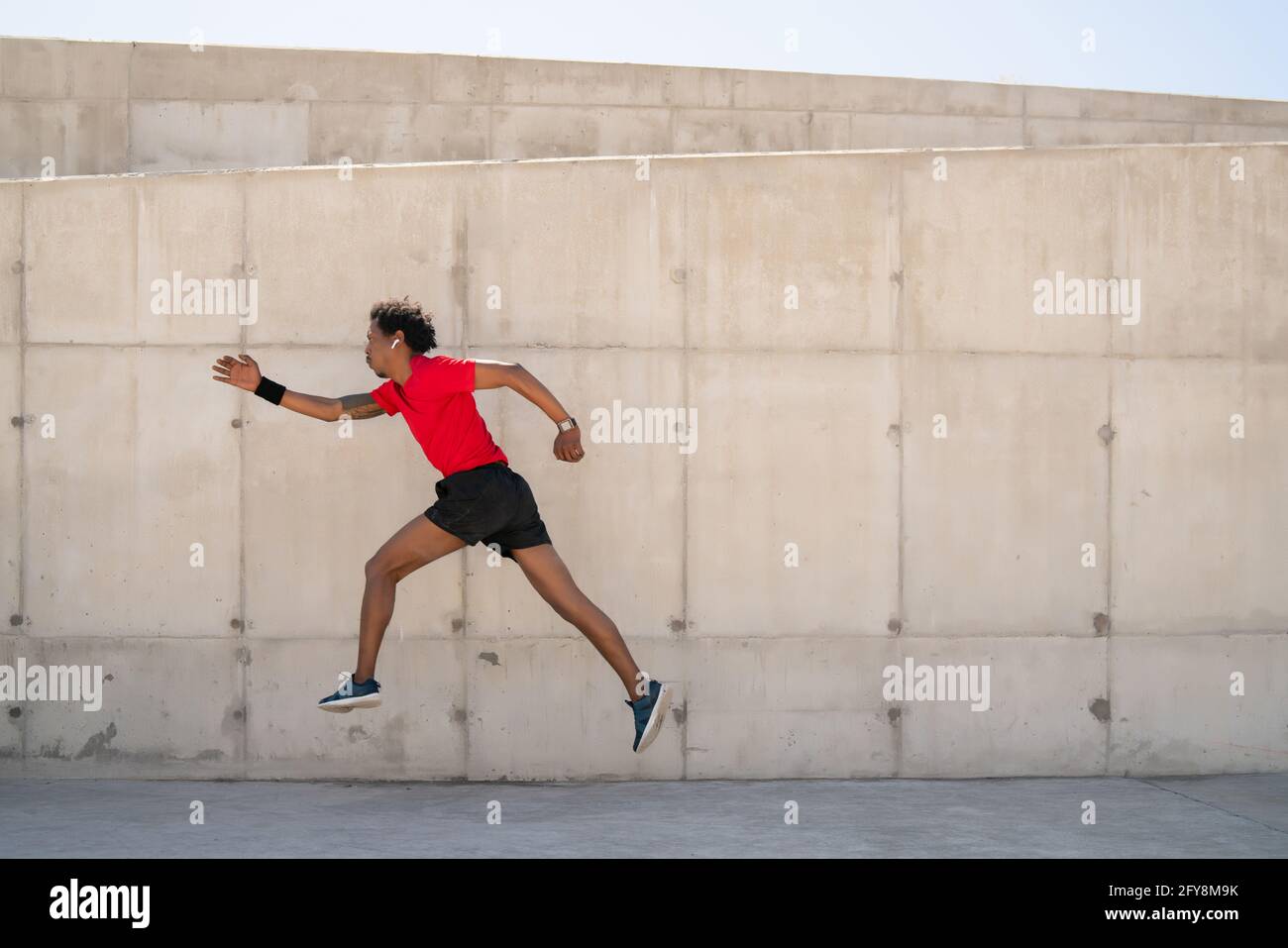 Athletic man running and doing exercise outdoors Stock Photo - Alamy