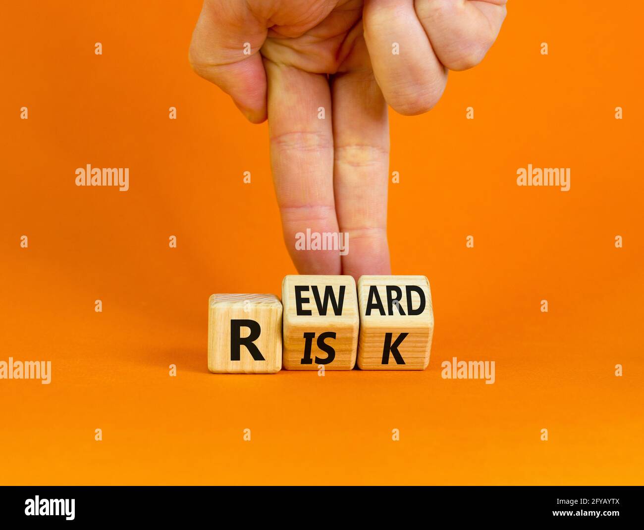 Risk or reward symbol. Businessman turns wooden cubes and changes the ...