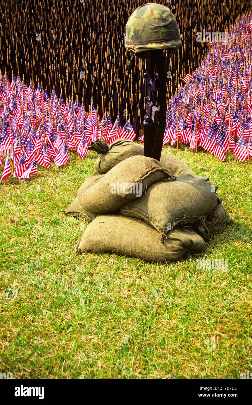 1970s VIETNAM MEMORIAL FLAGS HELMET RIFLE SANDBAGS - 087375 CAM002 HARS STILL LIFE PATRIOTIC SACRIFICE STARS AND STRIPES SUPPORT TRIBUTE ARMED FORCE HERO HONOR NAM PATRIOTISM RED WHITE AND BLUE VIET VIET NAM VIET NAM WAR DUTY MEMORIAL DAY OLD FASHIONED REMEMBRANCE Stock Photo