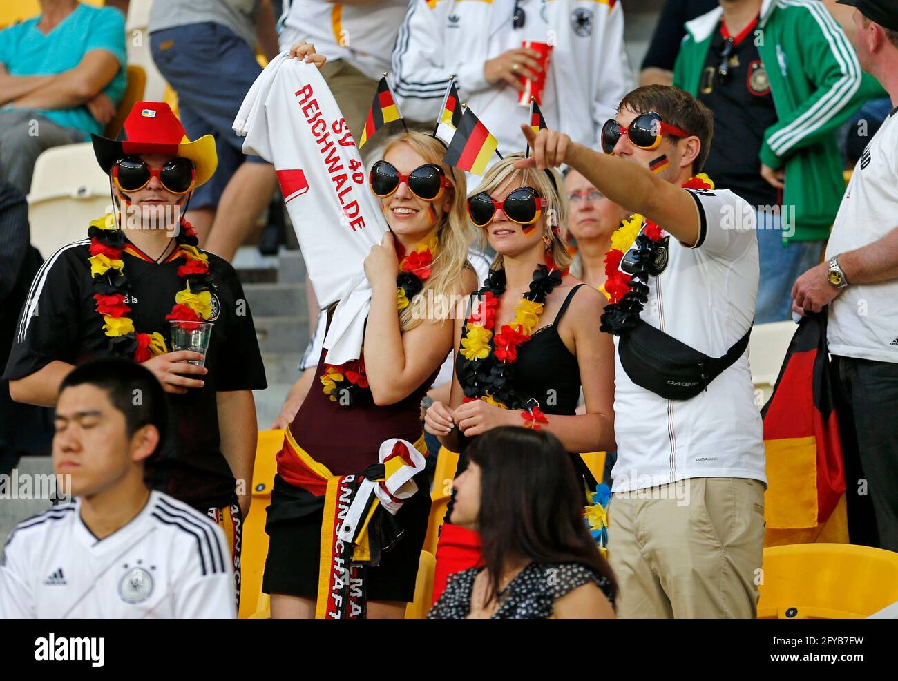LVIV, UKRAINE - JUNE 17, 2012: German football supporters show their support during the UEFA EURO 2012 game Germany v Denmark at Lviv Arena in Lviv. Germany won 2-1 Stock Photo