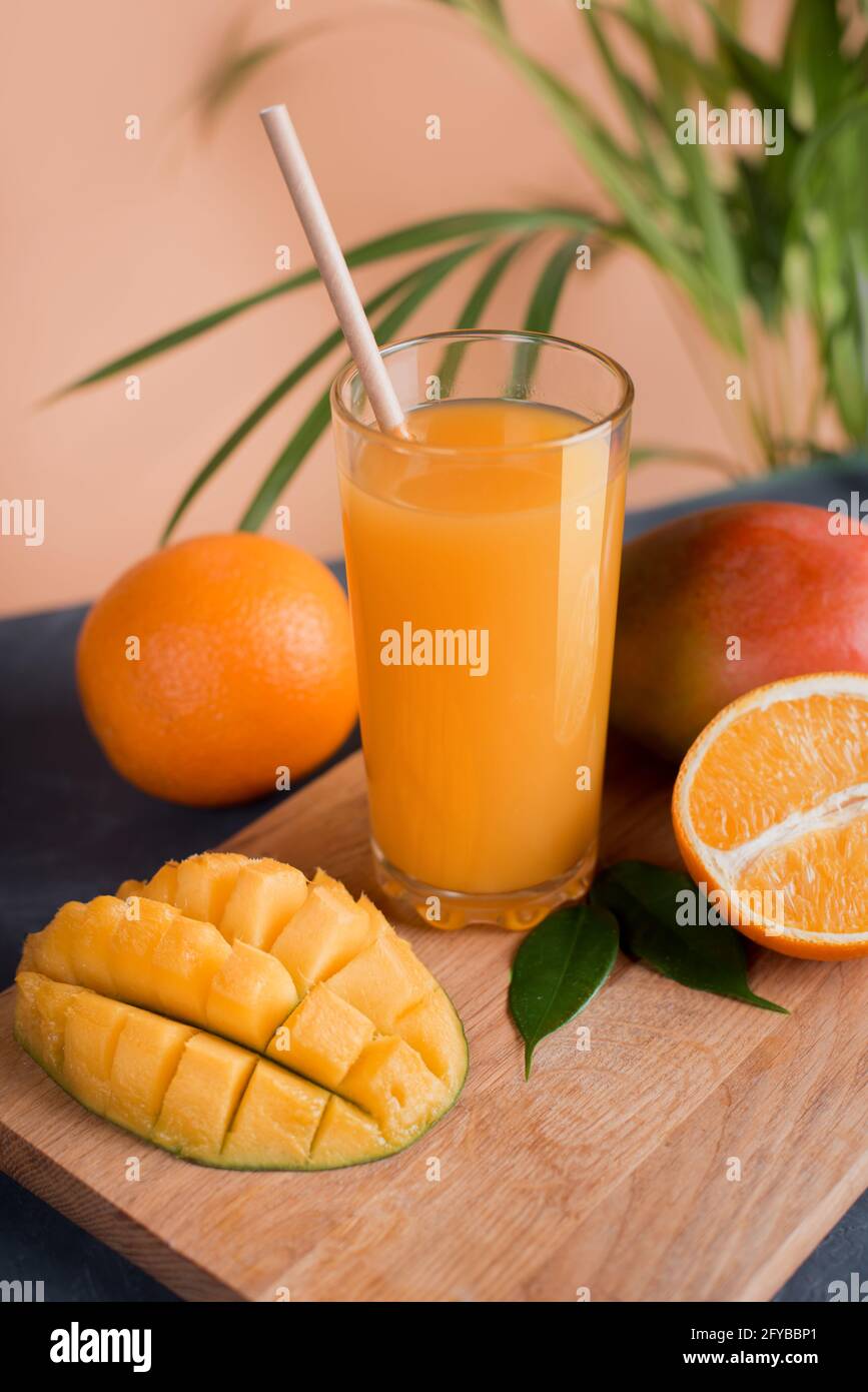 Fresh mango orange juice with ripe mangoes and orange fruit Stock Photo