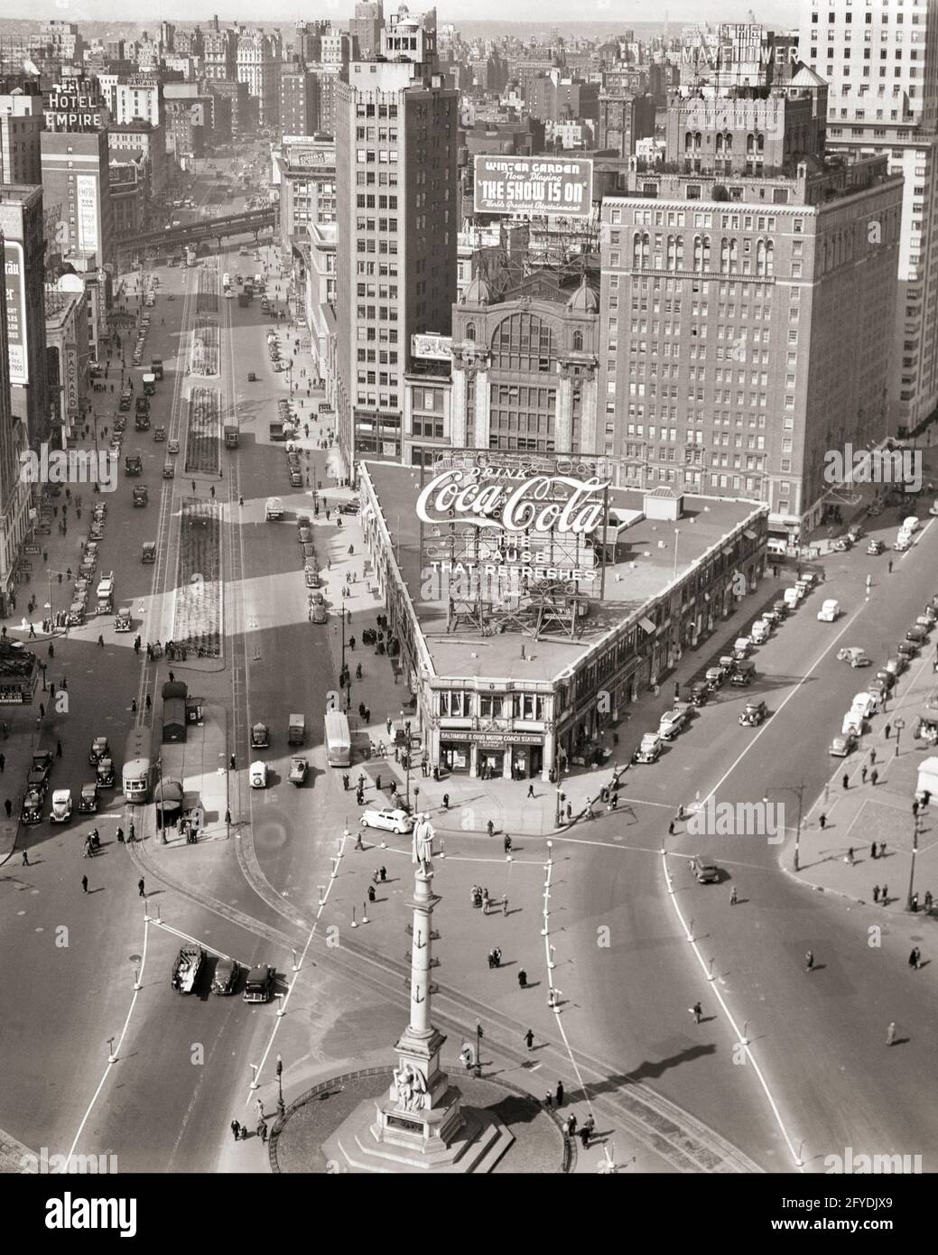 1930s COLUMBUS CIRCLE WITH INTERSECTION OF BROADWAY ON LEFT WITH TROLLEY CARS AND CENTRAL PARK WEST AND 59TH STREETS NYC USA - q49658 CPC001 HARS TRANSPORTATION MEASUREMENT B&W TRACKS NORTH AMERICA NORTH AMERICAN STRUCTURE HIGH ANGLE ADVENTURE INTERSECTION PROPERTY AND AUTOS EXTERIOR PROGRESS DIRECTION OPPORTUNITY NYC TROLLEY REAL ESTATE NEW YORK STRUCTURES AUTOMOBILES BUS STATION CITIES COLUMBUS CIRCLE VEHICLES EDIFICE NEW YORK CITY 59TH BROADWAY BLACK AND WHITE CENTRAL PARK CENTRAL PARK WEST CHRISTOPHER COLUMBUS COLUMBUS OLD FASHIONED UPPER WEST SIDE Stock Photo