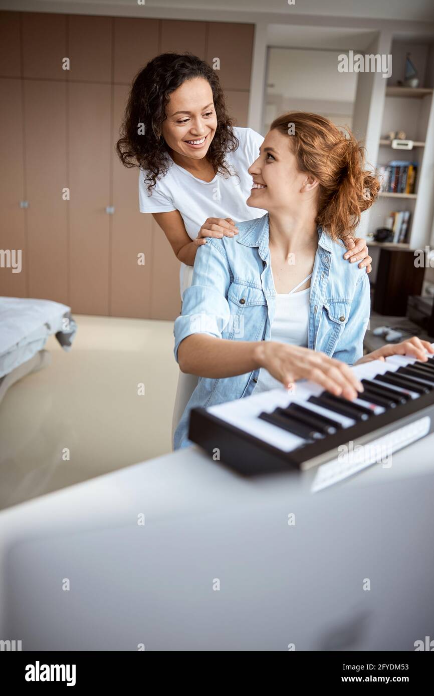 Cheerful two ladies looking at each other Stock Photo