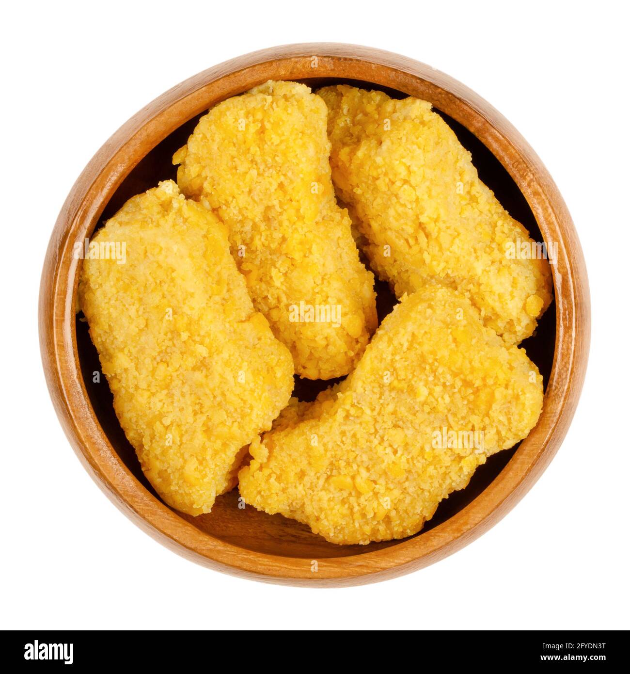 Vegan nuggets, ready to fry, in a wooden bowl. Vegan nuggets, based on soy and wheat protein, in crispy breading, pre-fried and cooked. Close-up. Stock Photo