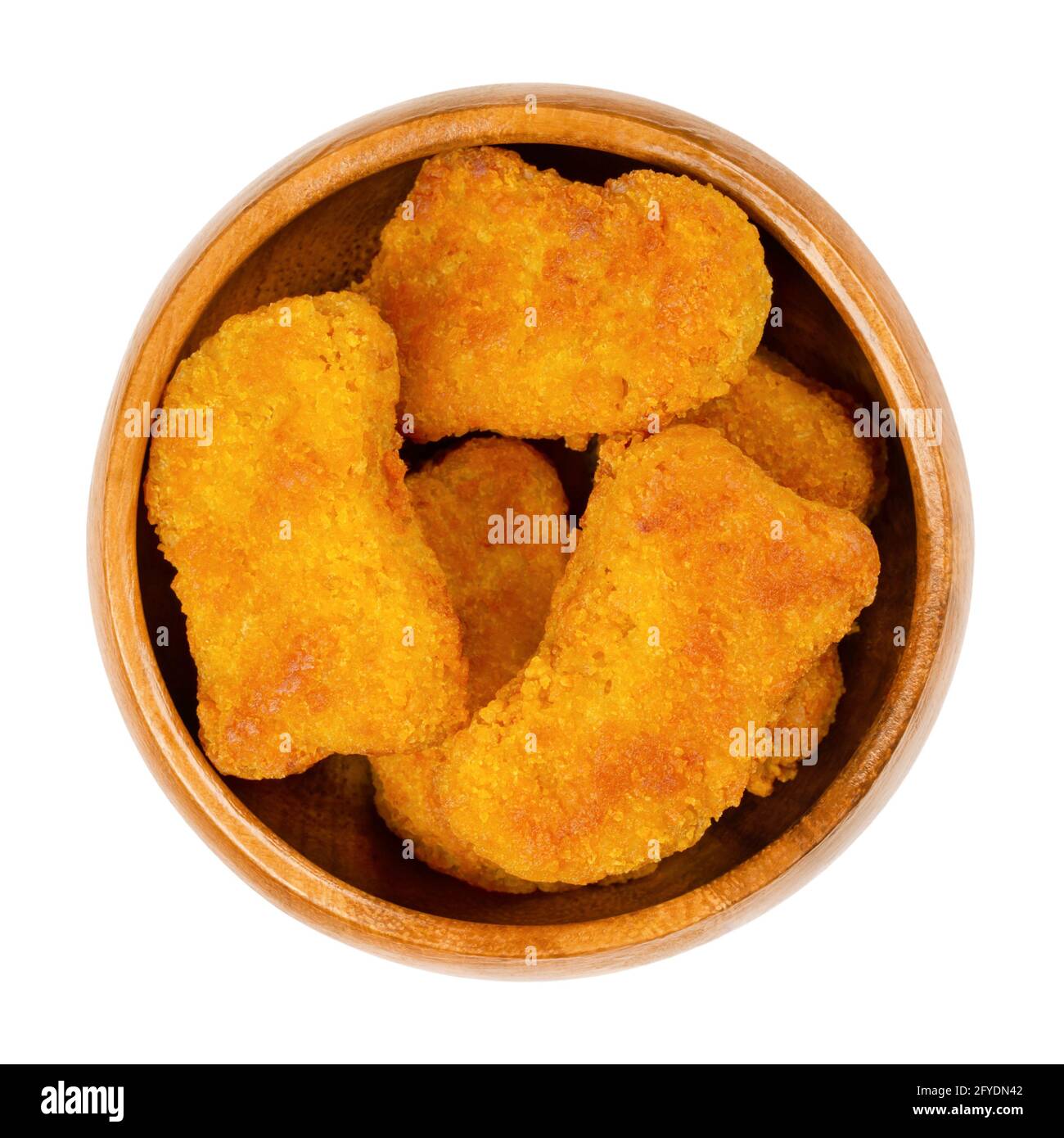 Deep-fried vegan nuggets, in a wooden bowl. Vegan nuggets, based on soy and wheat protein, in crispy breading. Fast food and snack. Close-up. Stock Photo
