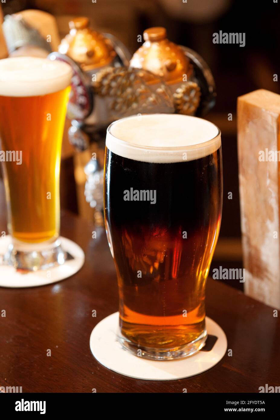 Pints of ale and lager on the bar top of an Irish pub.  Whistler BC, Canada. Stock Photo