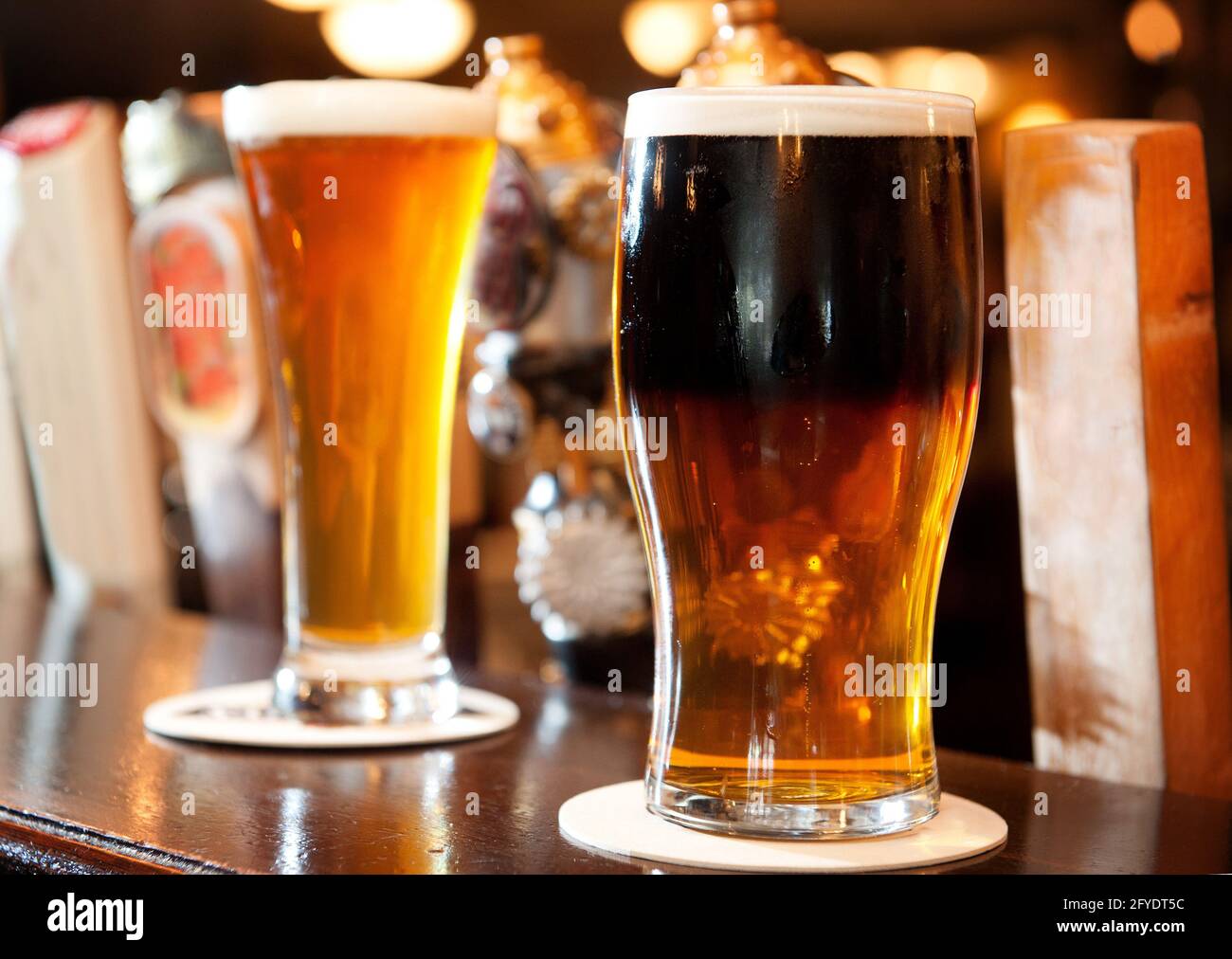 Pints of ale and lager on the bar top of an Irish pub.  Whistler BC, Canada. Stock Photo