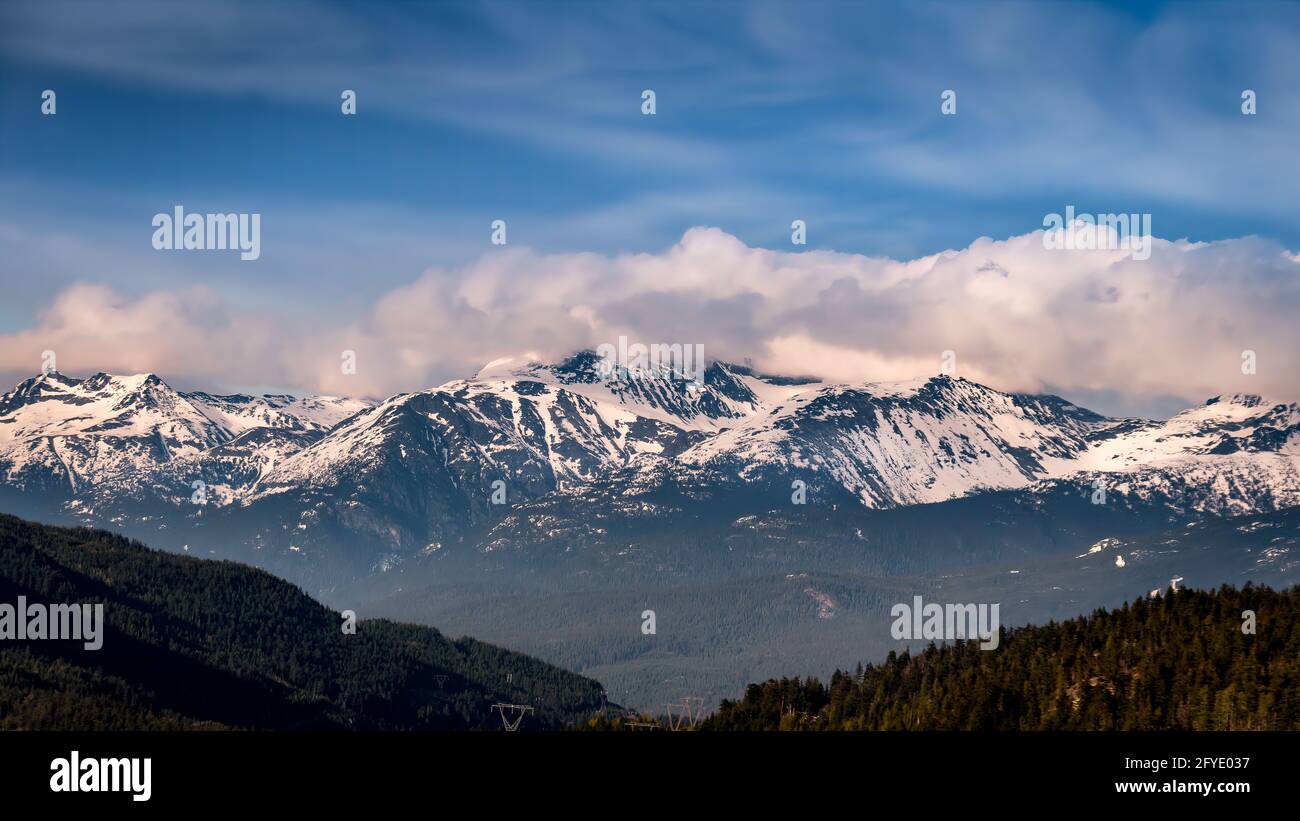 Cloud blanket hanging over the mountains just north of Whistler in the Garibaldi Mountain Range of British Columbia, Canada Stock Photo