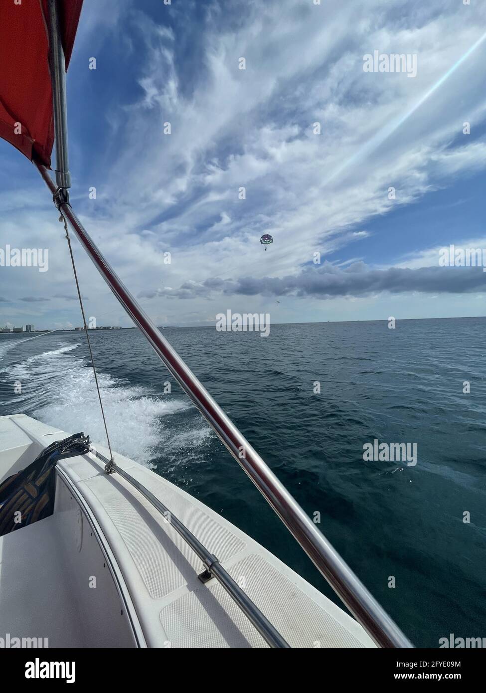 View of the sea and the parachute flying in the sky from a yacht Stock Photo