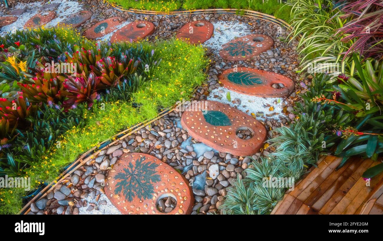 Stepping Stones in a Garden with Plants and Trees Stock Photo - Alamy