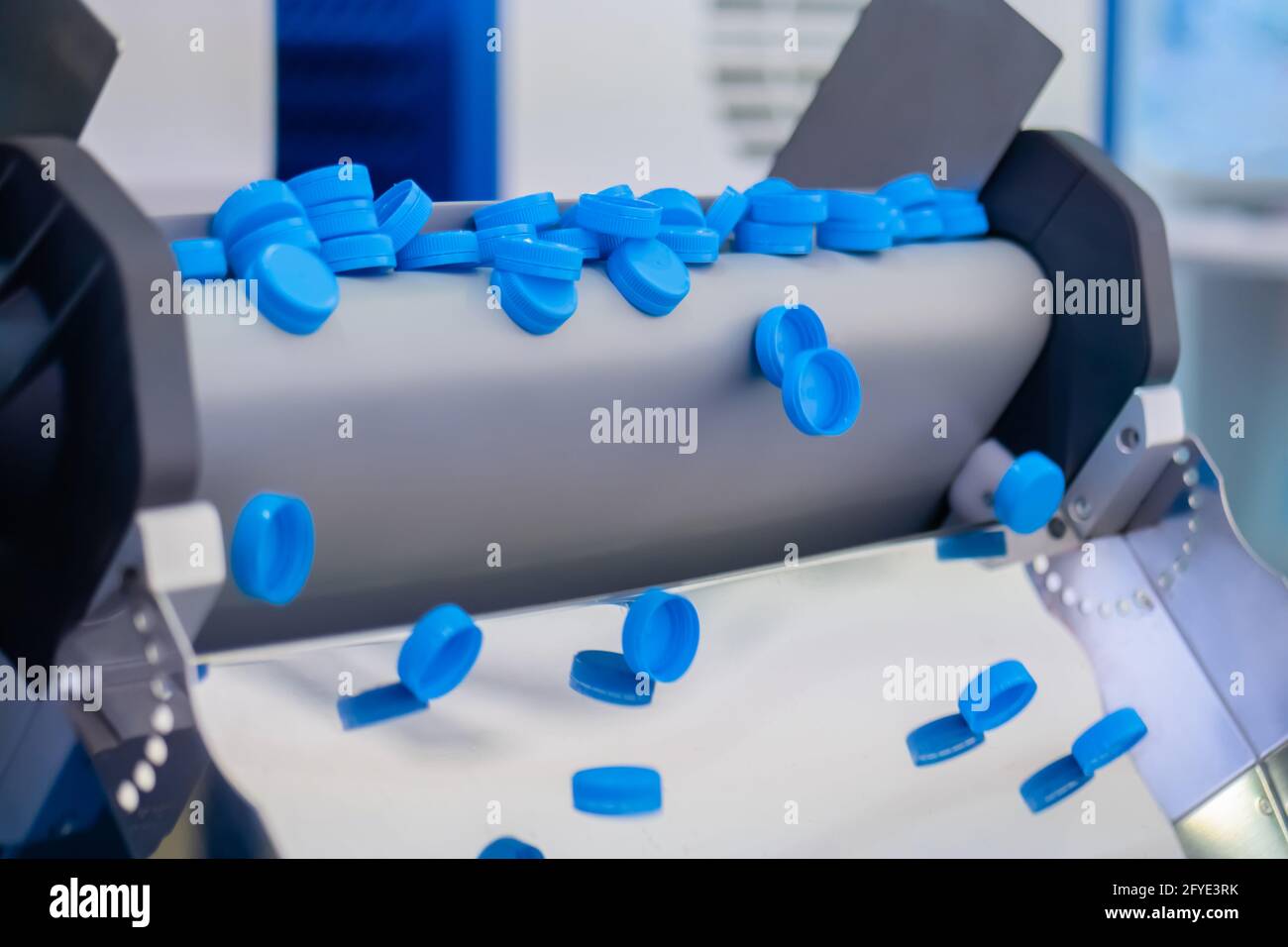 Many blue plastic bottle caps falling from conveyor belt production line Stock Photo Alamy