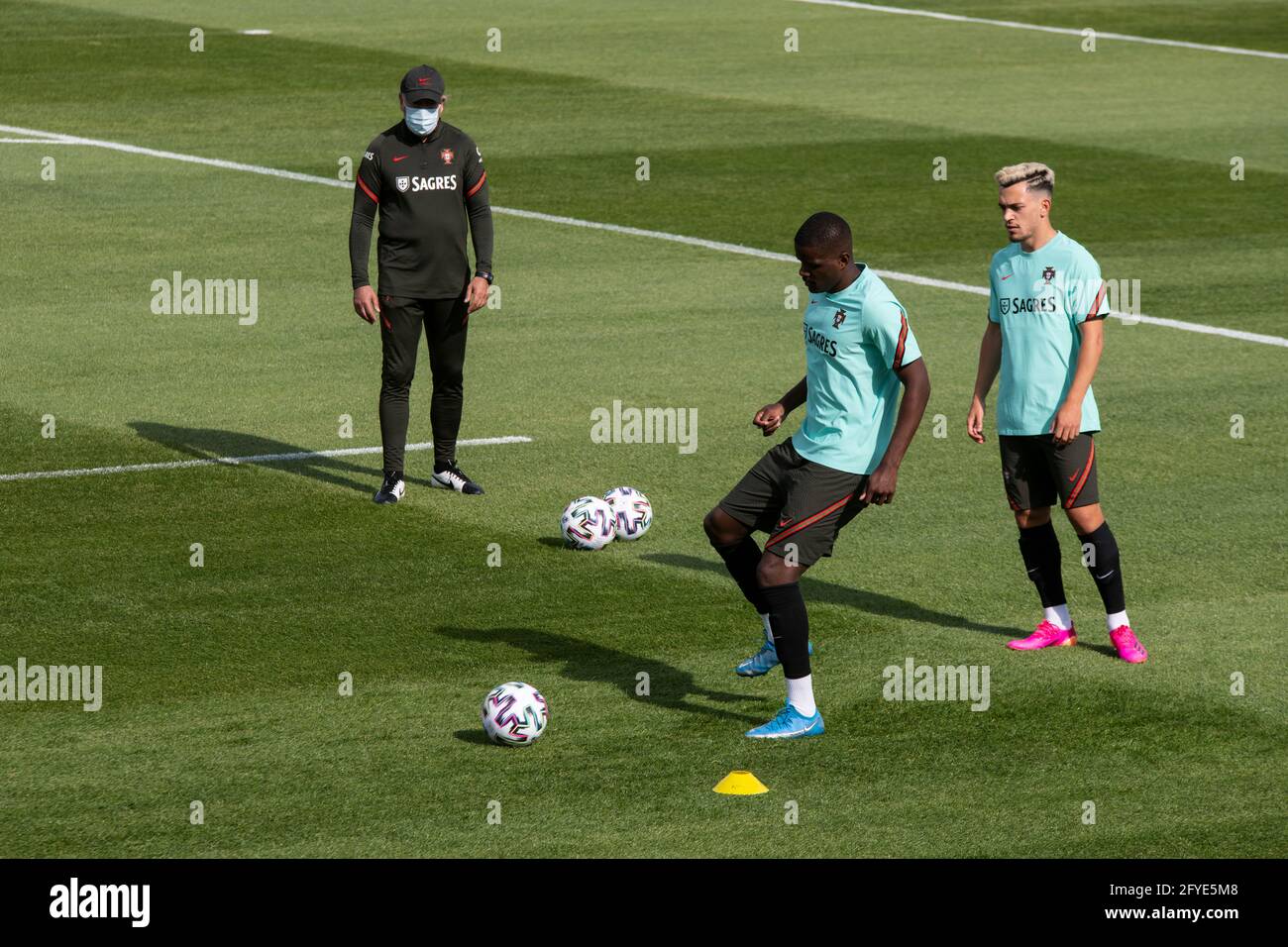 Oeiras, Portugal. 27th May, 2021. William Carvalho (C) and Pedro Goncalves (R) are seen in action during the training session at Cidade do Futebol training ground in Oeiras.Portugal football team trains for the first time before competing in the European football championship - EURO 2020 - scheduled to start on June 11th. Credit: SOPA Images Limited/Alamy Live News Stock Photo