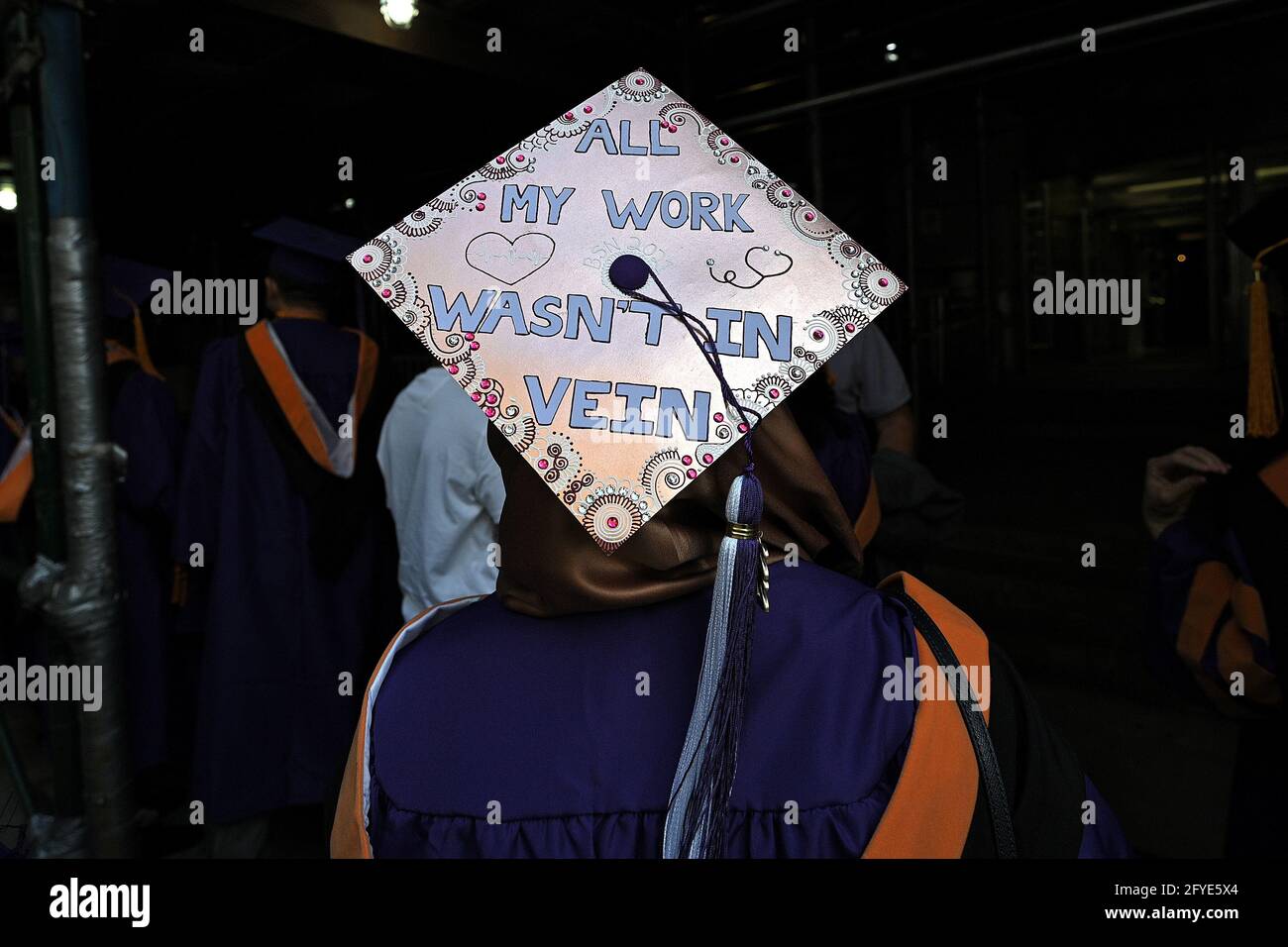 New York, USA. 27th May, 2021. A graduate wears a decorated cap as she