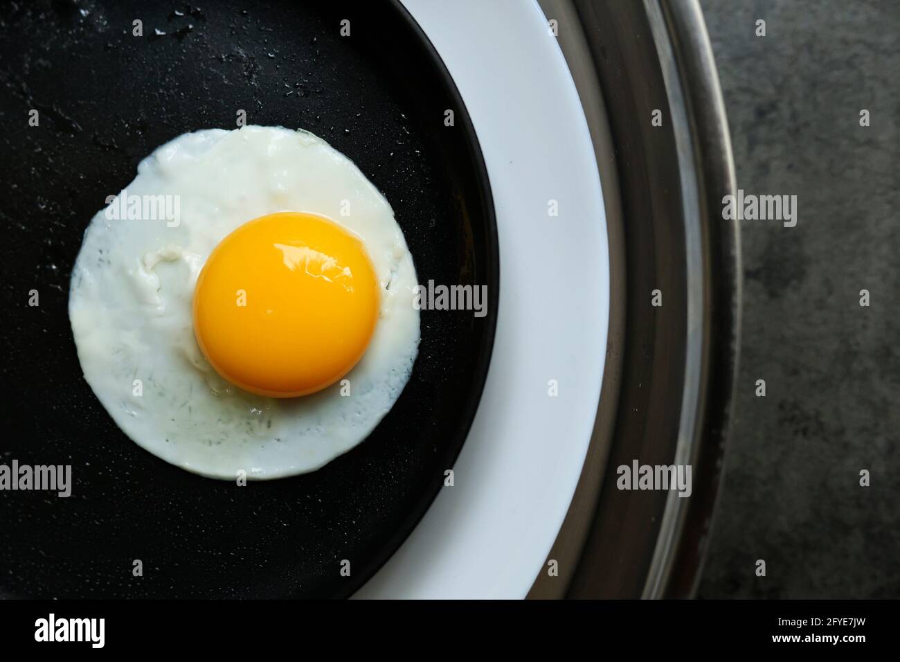 a fried egg in a pan, in 2 plate Stock Photo