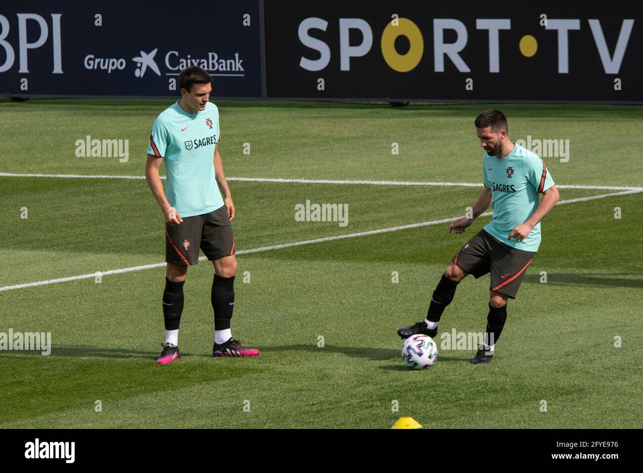 Oeiras, Portugal. 27th May, 2021. Joao Moutinho (R) and ...