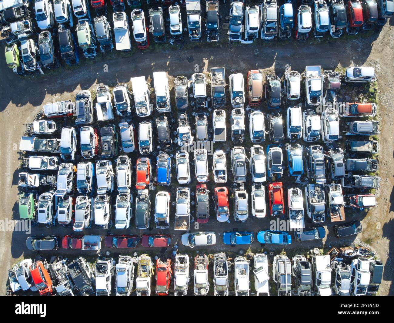 Car yard aerial view showing crashed and wrecked cars for salvage