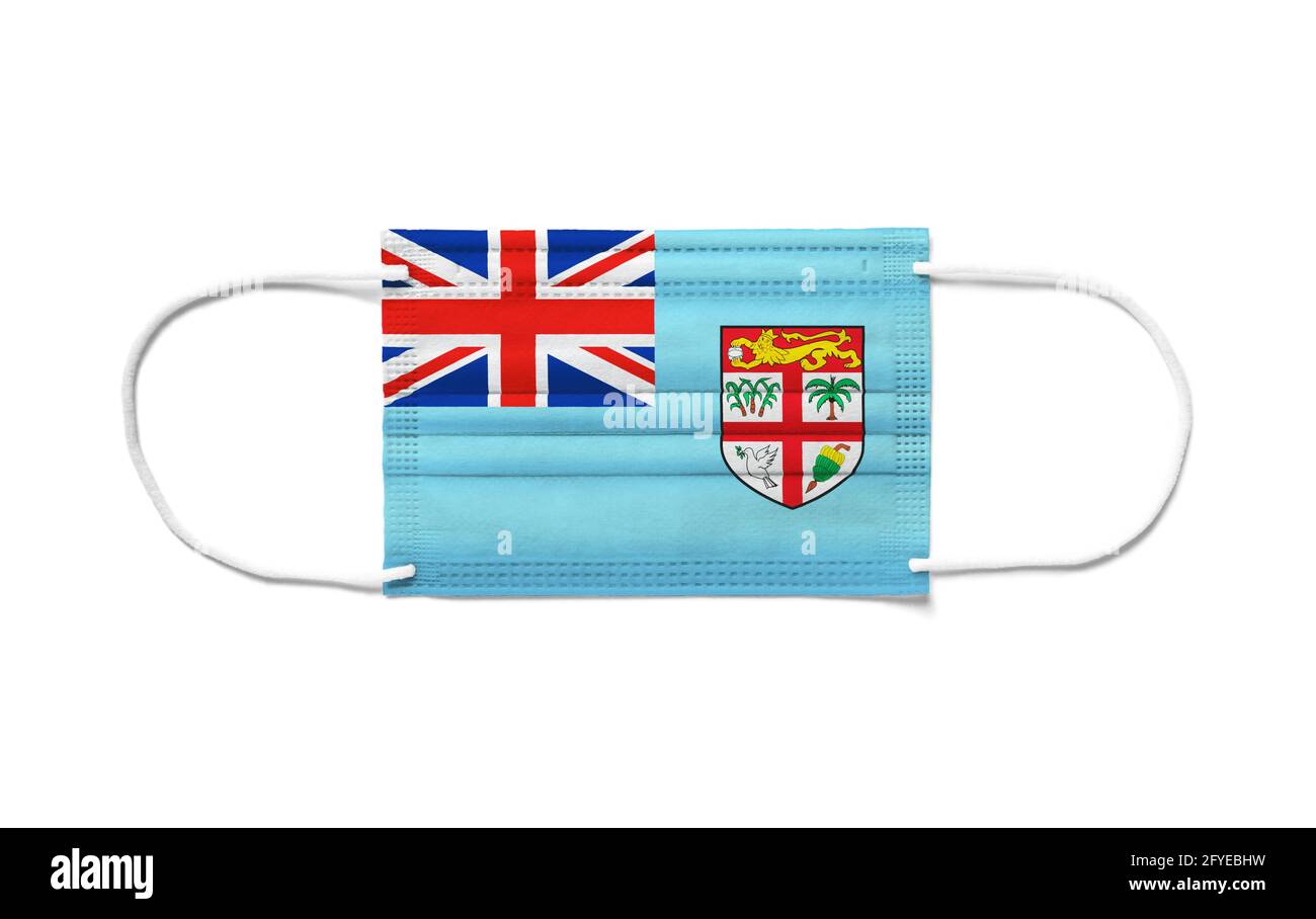 Flag of Fiji on a disposable surgical mask. White background isolated Stock Photo